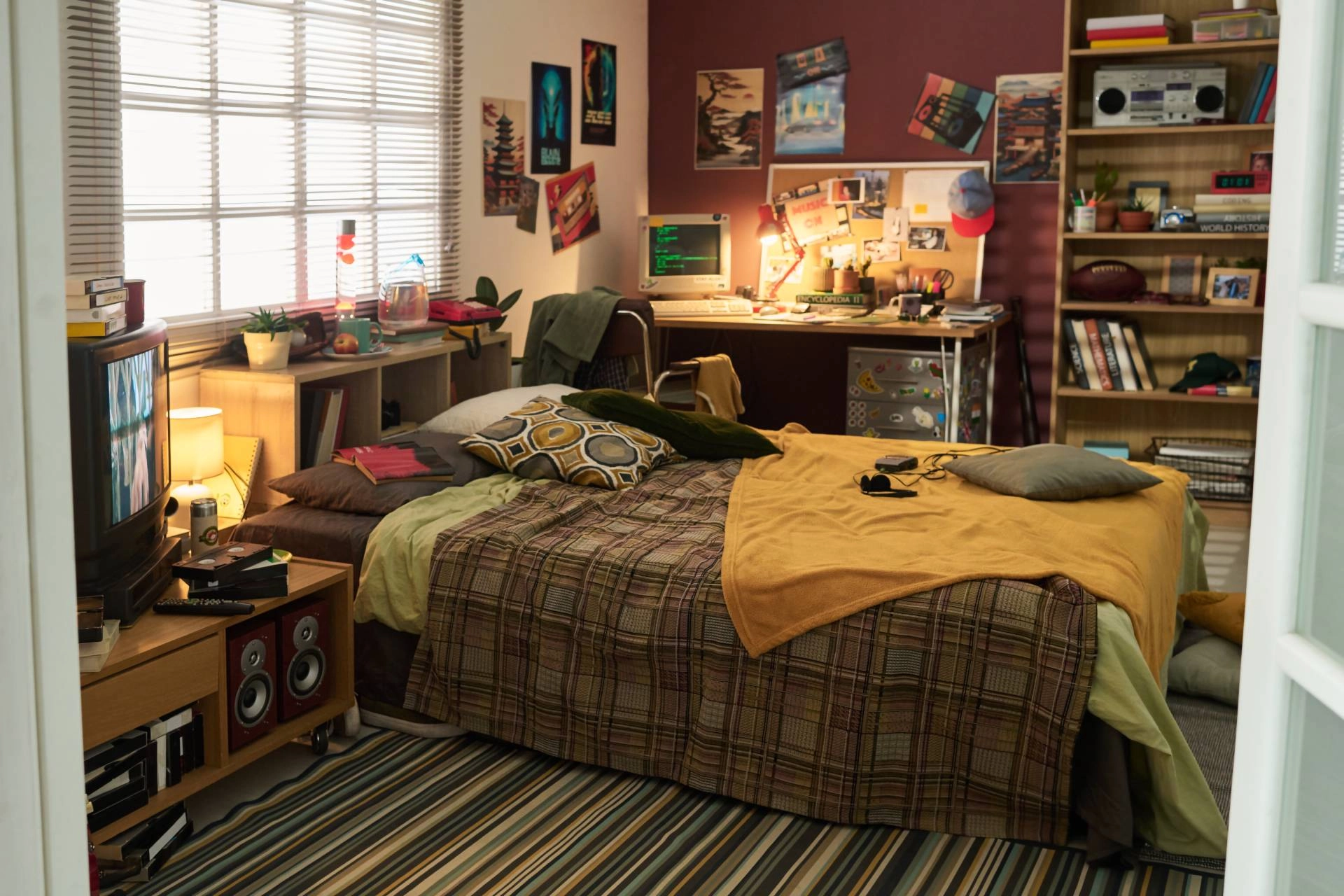An inspired '80s style bedroom with metal window blinds on the window above the bed