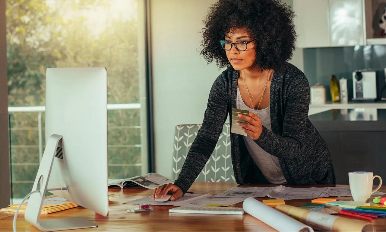 Woman working on a computer as a New Hunter Douglas Business Owner