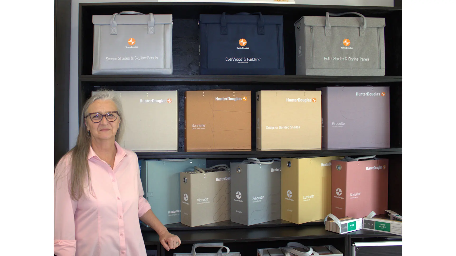 Owner with Hunter Douglas design books.