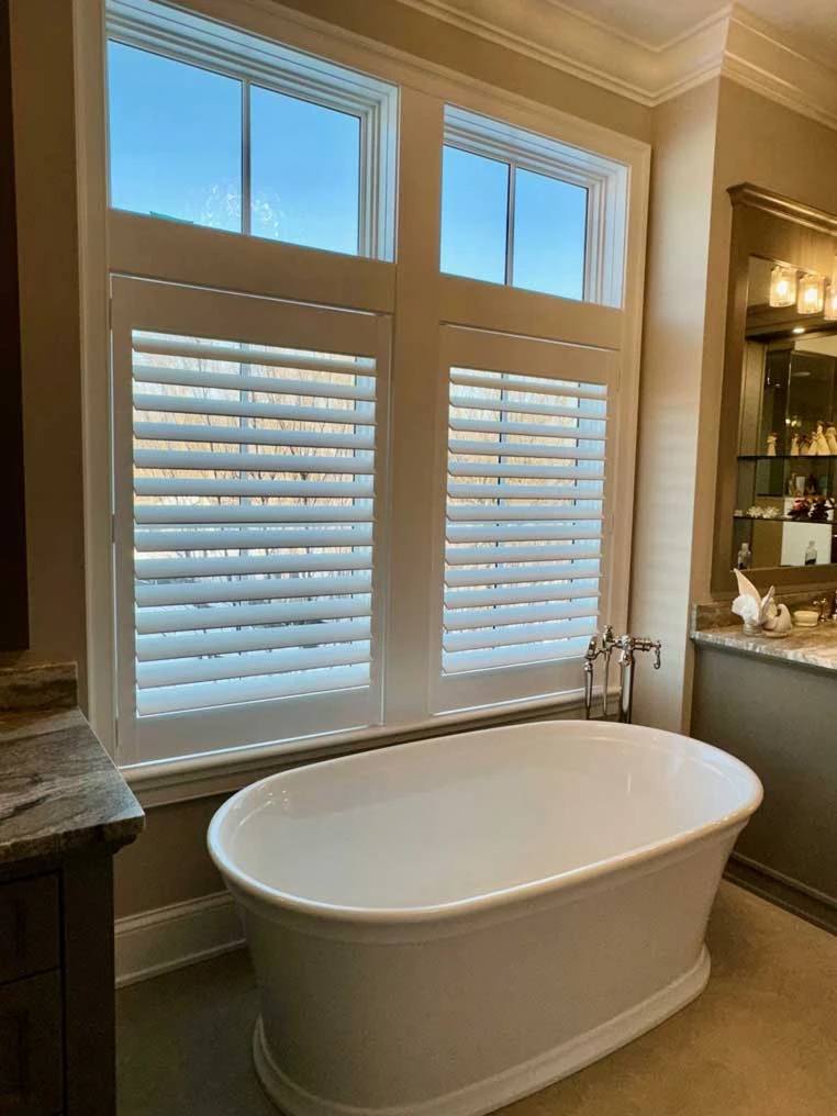 Bathroom windows with Hunter Douglas shutters.