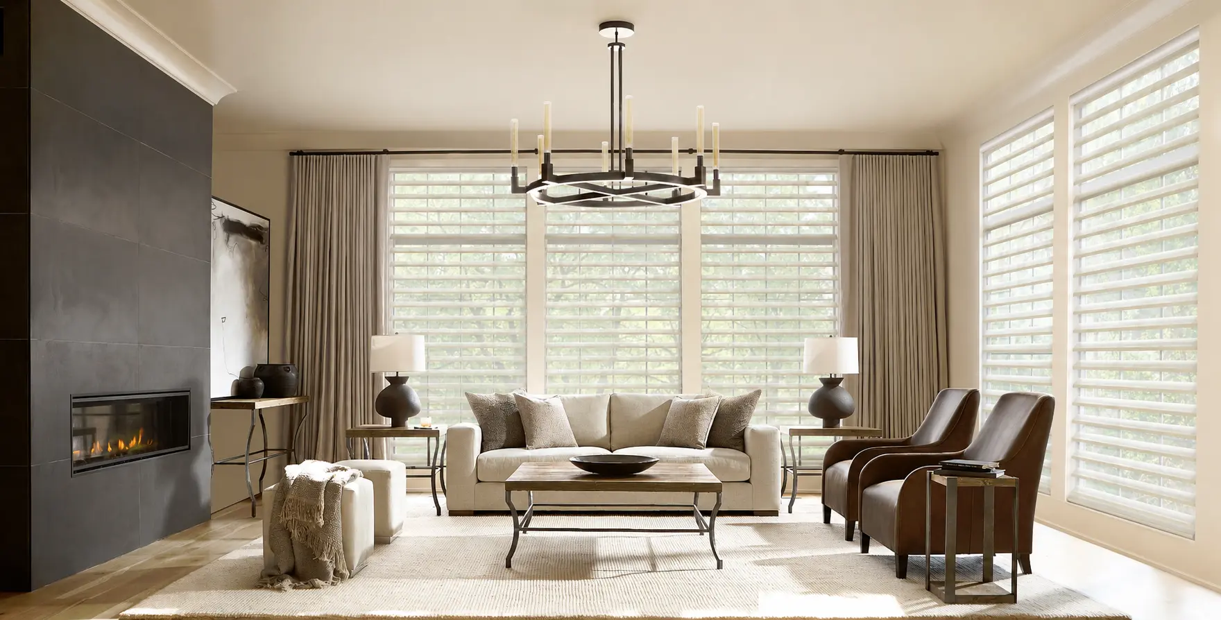 A living room with large windows featuring Hunter Douglas shades.
