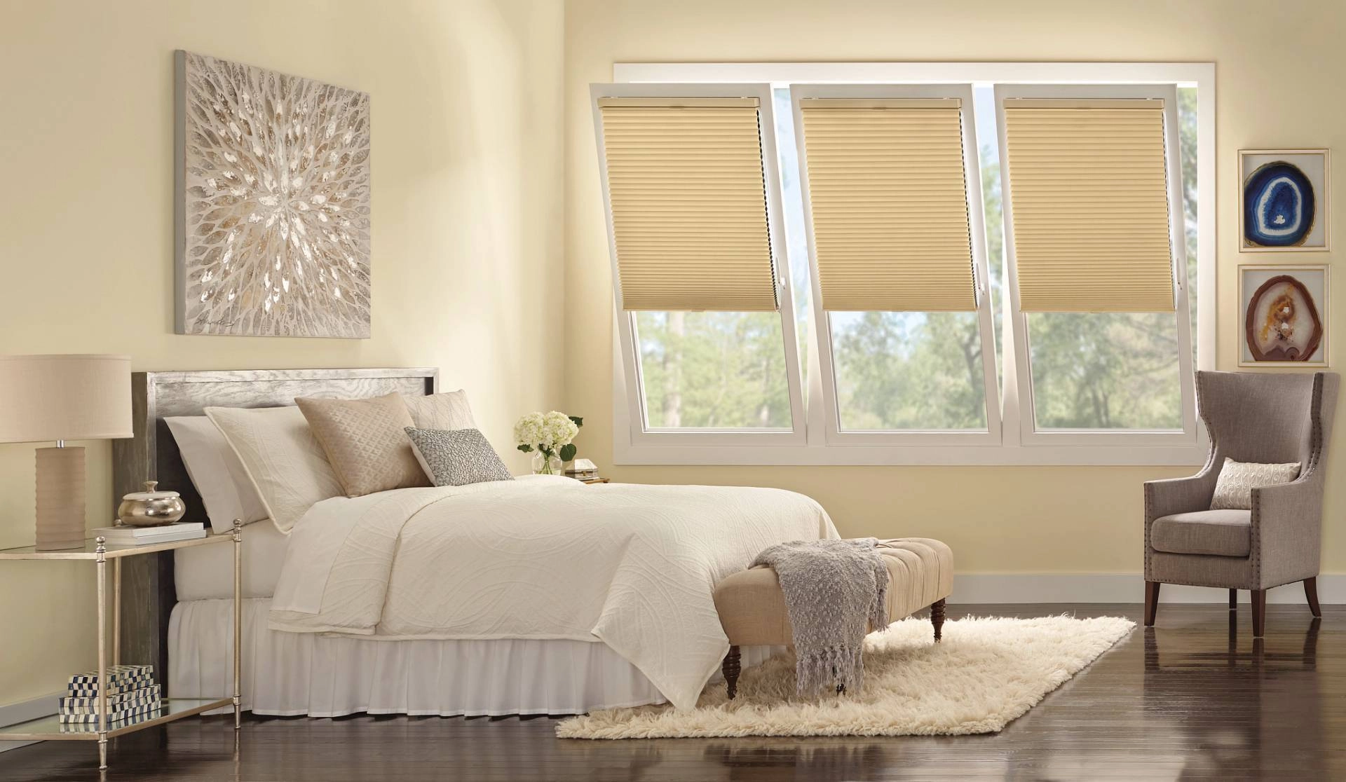 Modern bedroom with three turn and tilt windows covered by Duette® Cellular Shades near Youngstown, OH.