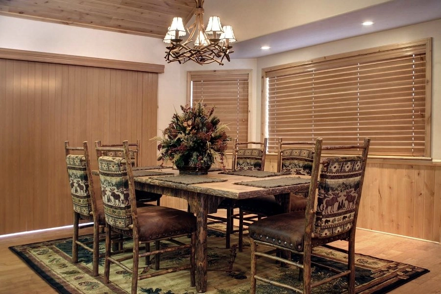 Dining room with windows featuring Hunter Douglas blinds.