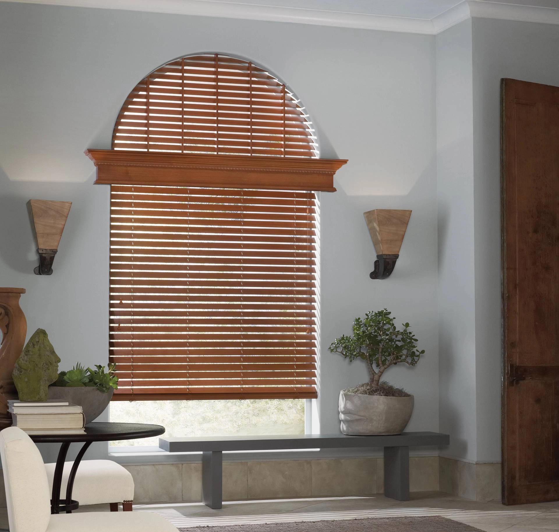 Parkland® Wood Blinds stained to coordinate with a living room color palette.