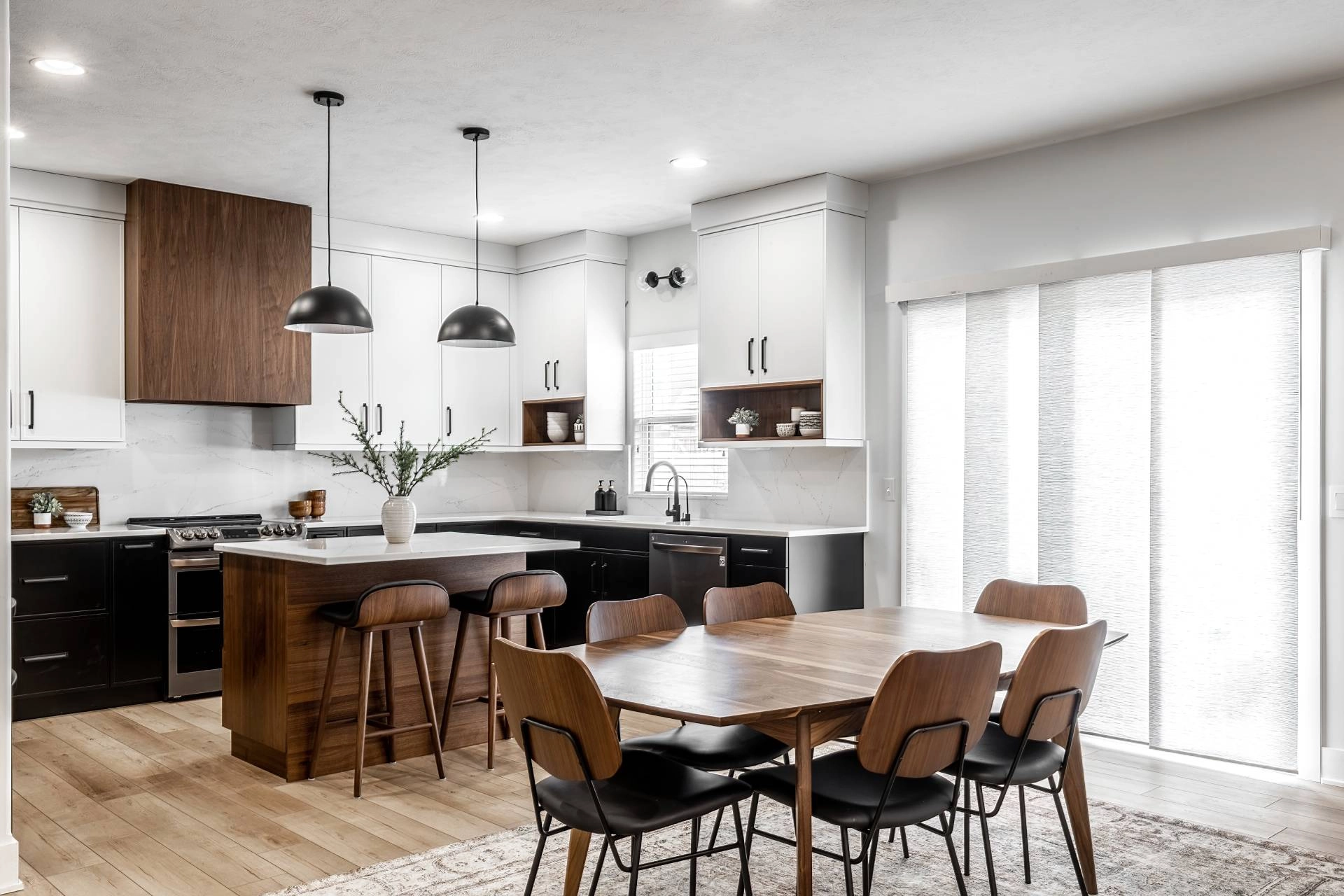 Mid century modern kitchen with vertical shades covering a patio door.