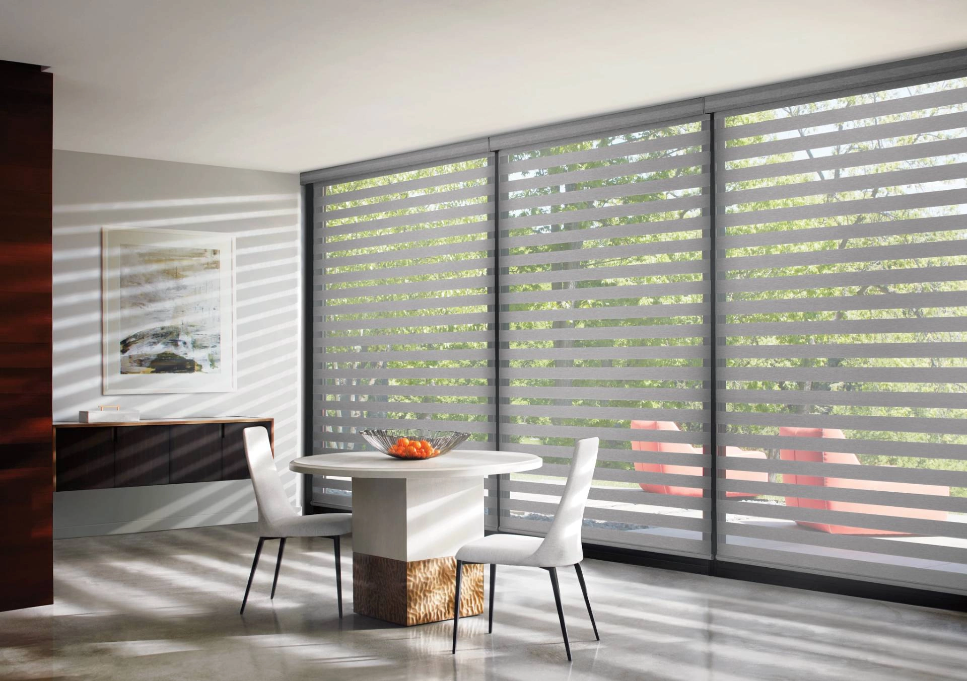 Hunter Douglas Banded Shades managing light in an open-concept dining area.