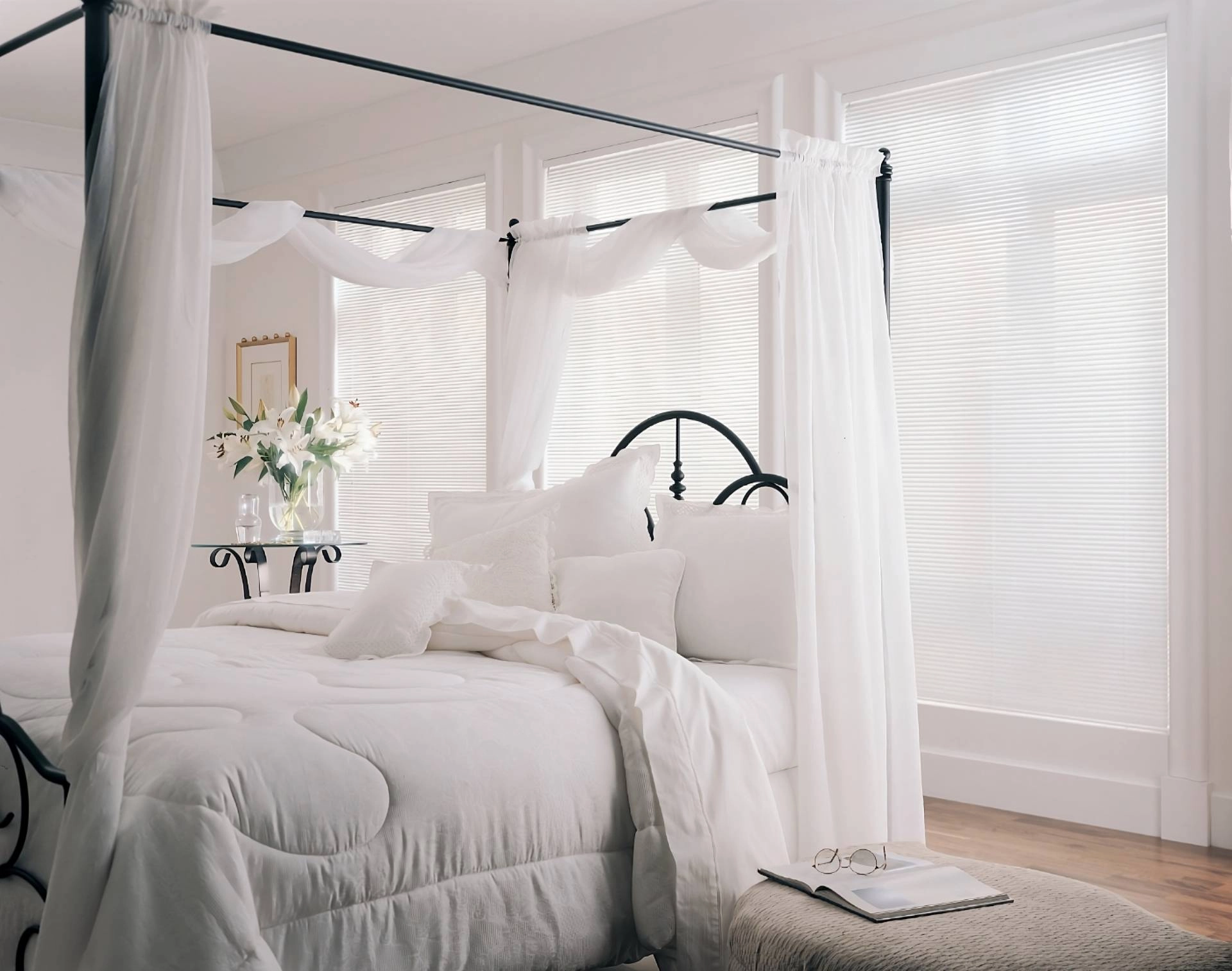 Dreamy and white Hunter Douglas custom blinds on three large windows in a light bedroom near Jupiter, FL