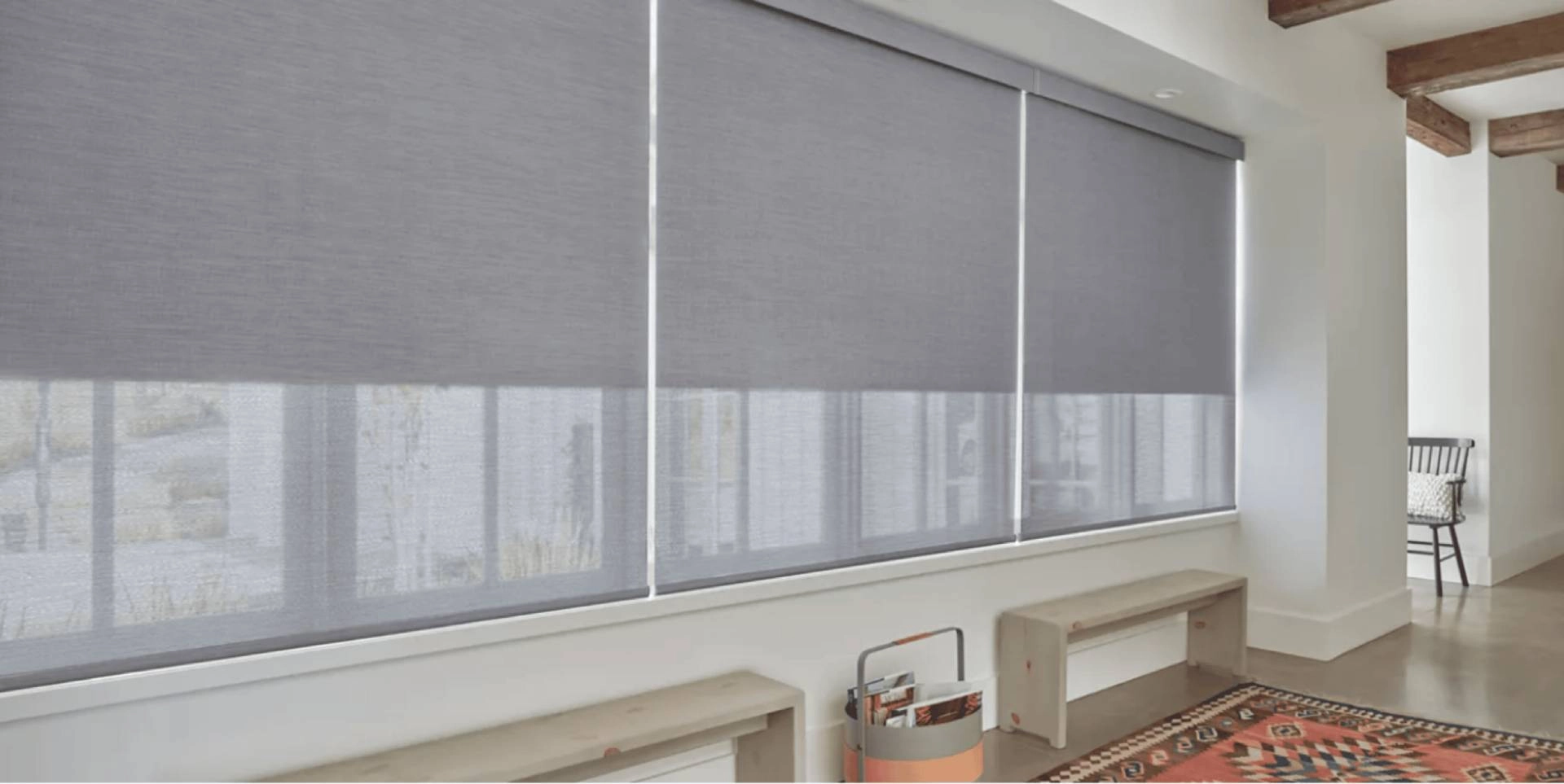 Hunter Douglas Designer Roller Shades covering large window in a hallway near Gresham, OR