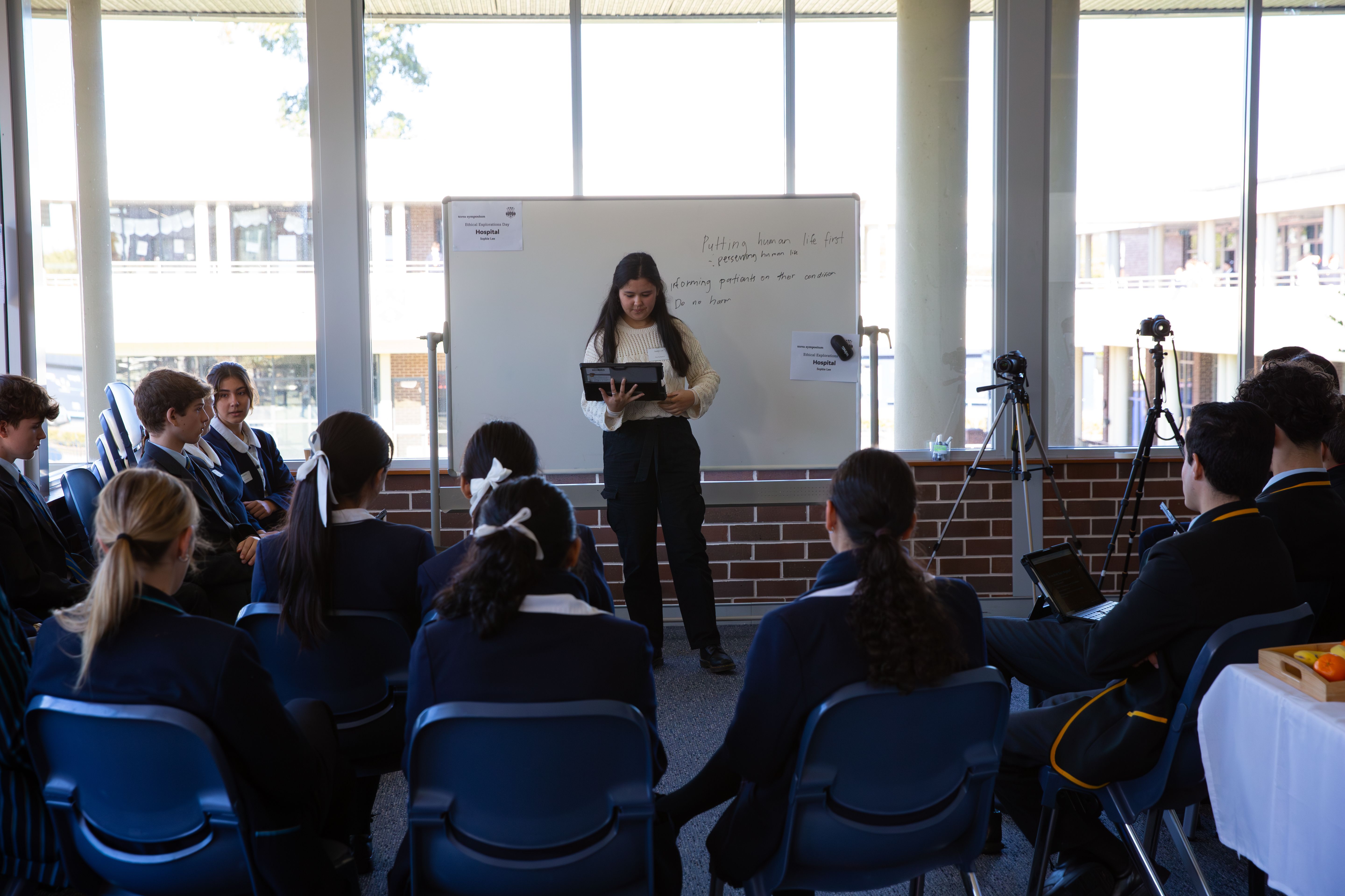 A student presenting to a group during a Terra Symposium workshop.