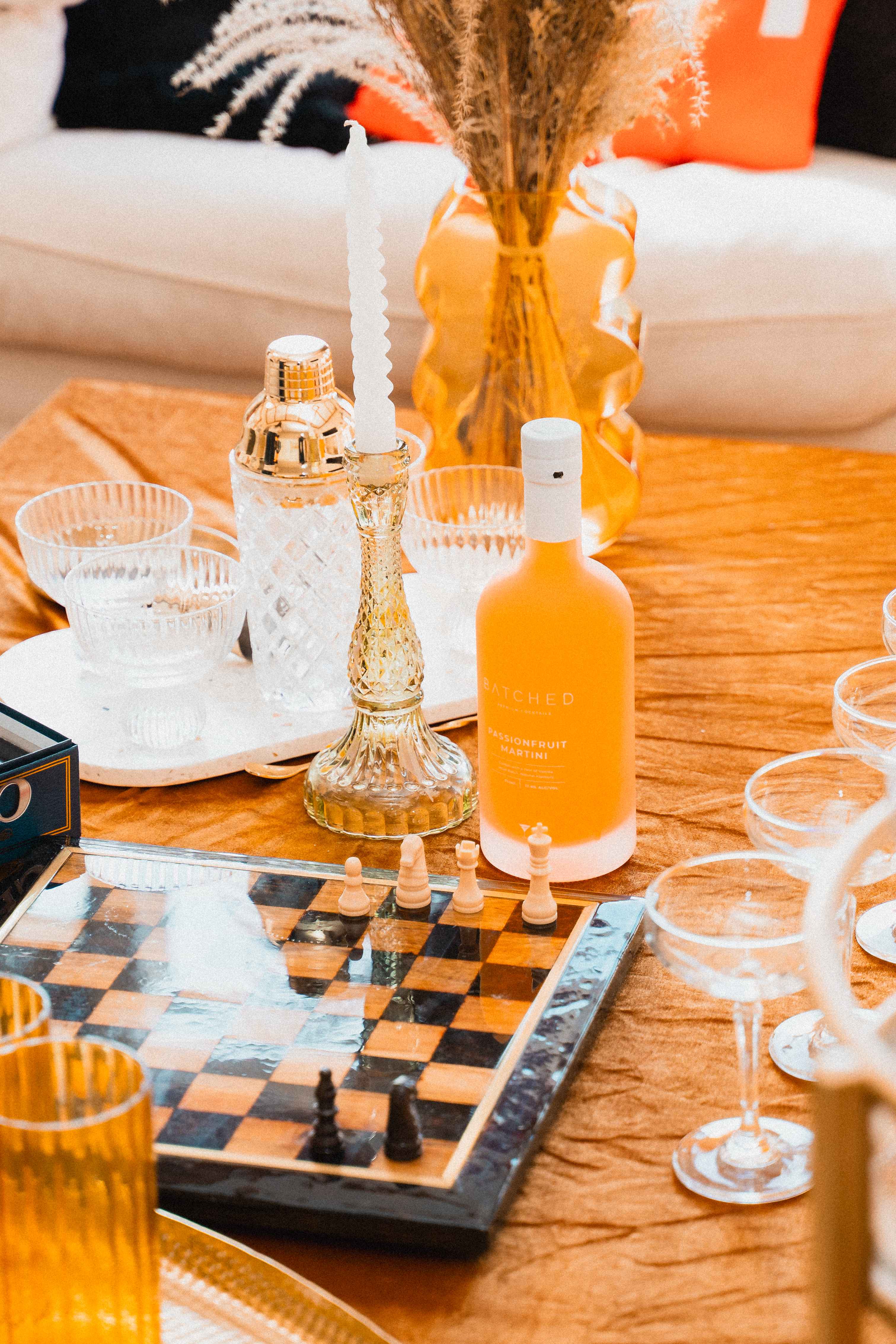 Batched Passionfruit Martini on table with chess board and decorations