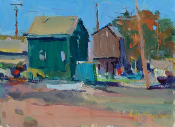 plein air painting of two colorful sheds with laundry on a rural dirt road