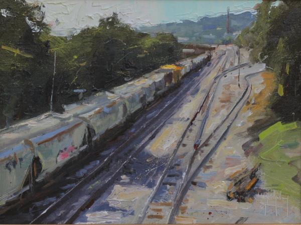 plein air painting of freight train on railroad tracks through wooded hills