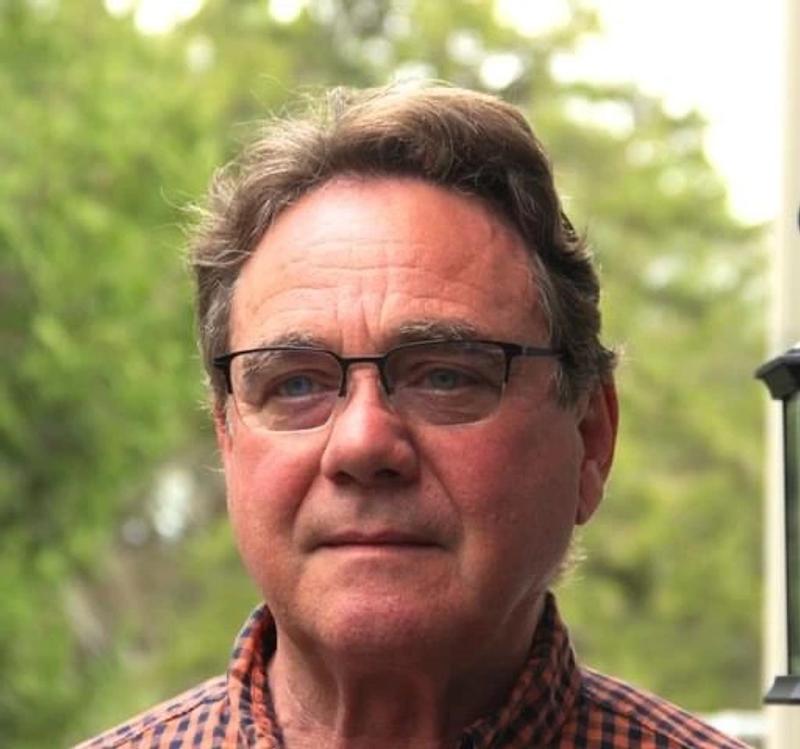 man wearing glasses outdoors in plaid button-up shirt