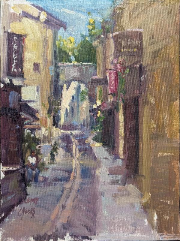 plein air painting of narrow stone alley with arch and shops in provence