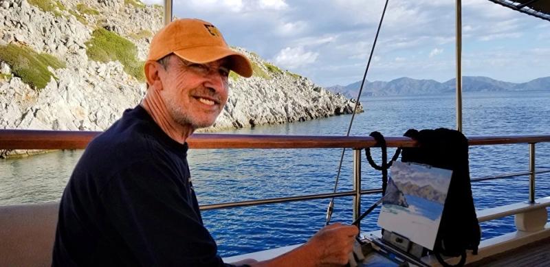 artist painting coastal landscape aboard boat near rocky shoreline