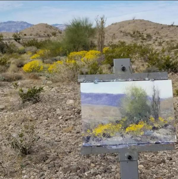 plein air painting of artist easel in desert with yellow wildflowers