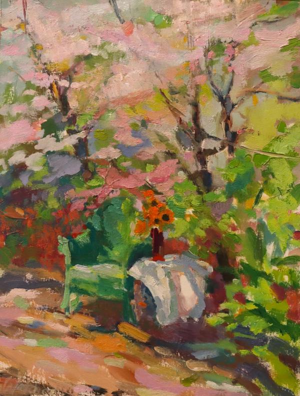 plein air painting of garden with pink blooming trees and outdoor table