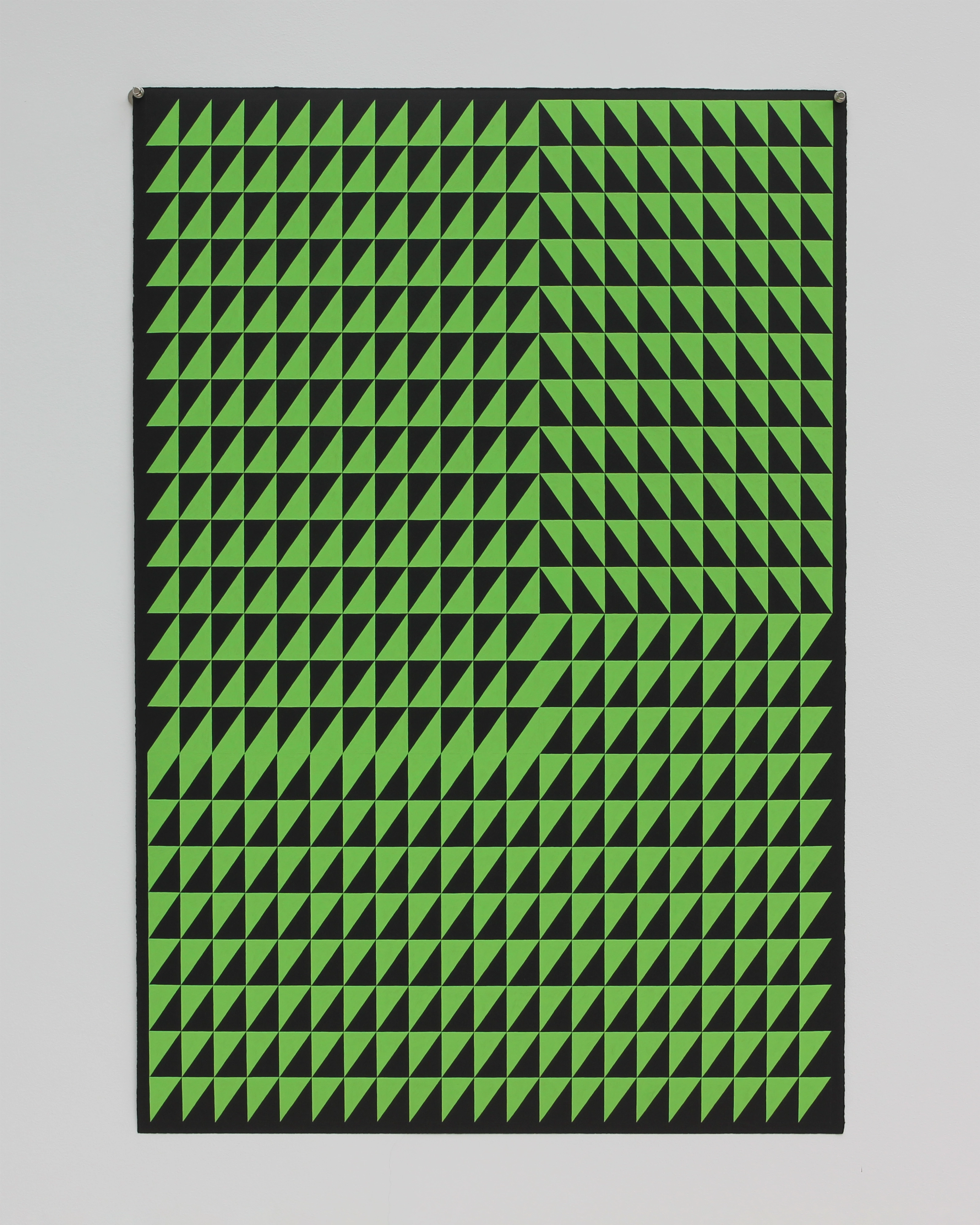 Bright lime-green triangular grid pattern on black paper, with subtle variations in triangle orientation creating a dynamic optical effect across the composi…
