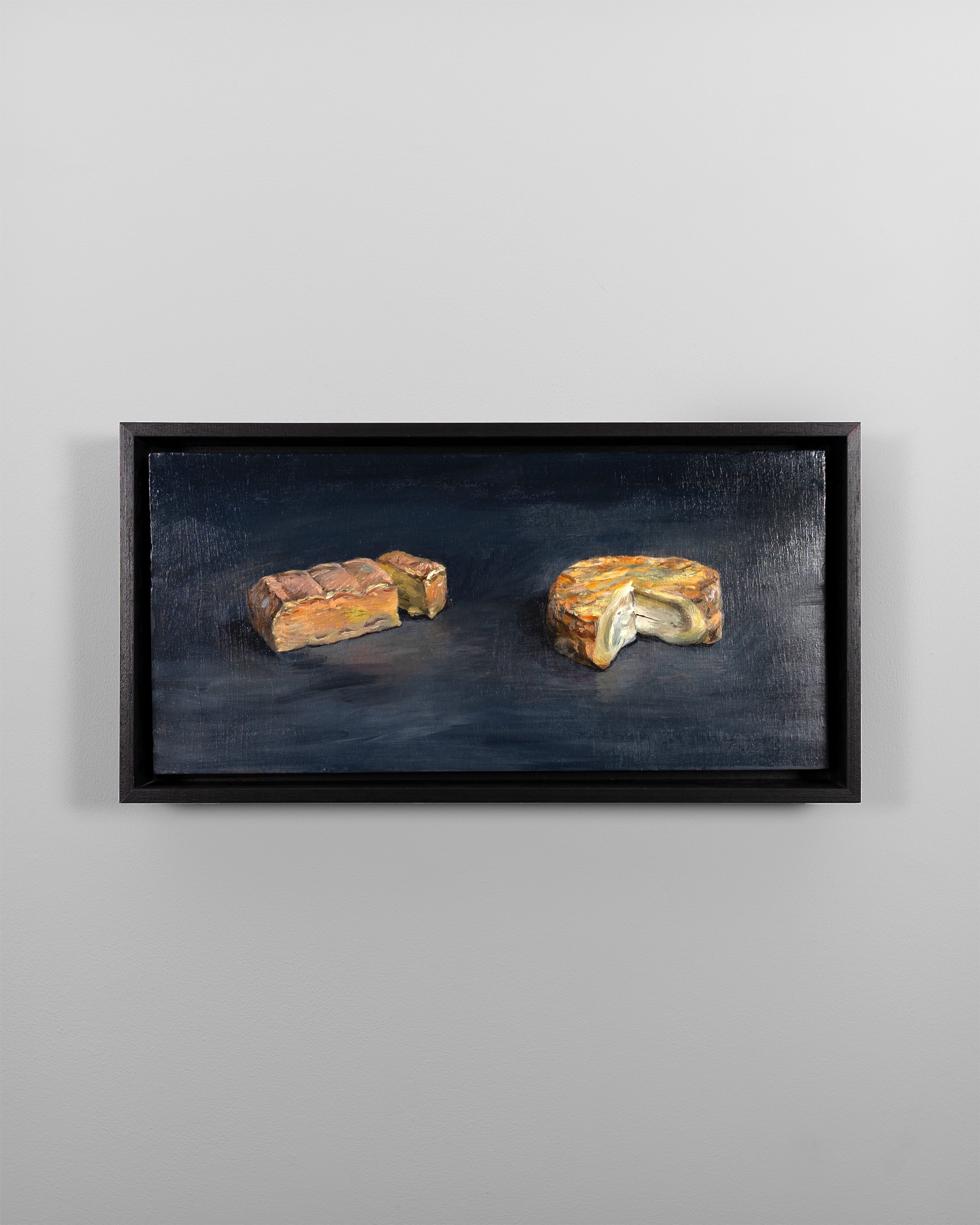 Oil painting on dark blue-grey ground depicting two sliced cheese wedges with golden-brown and cream surfaces, set against a dark atmospheric background with…