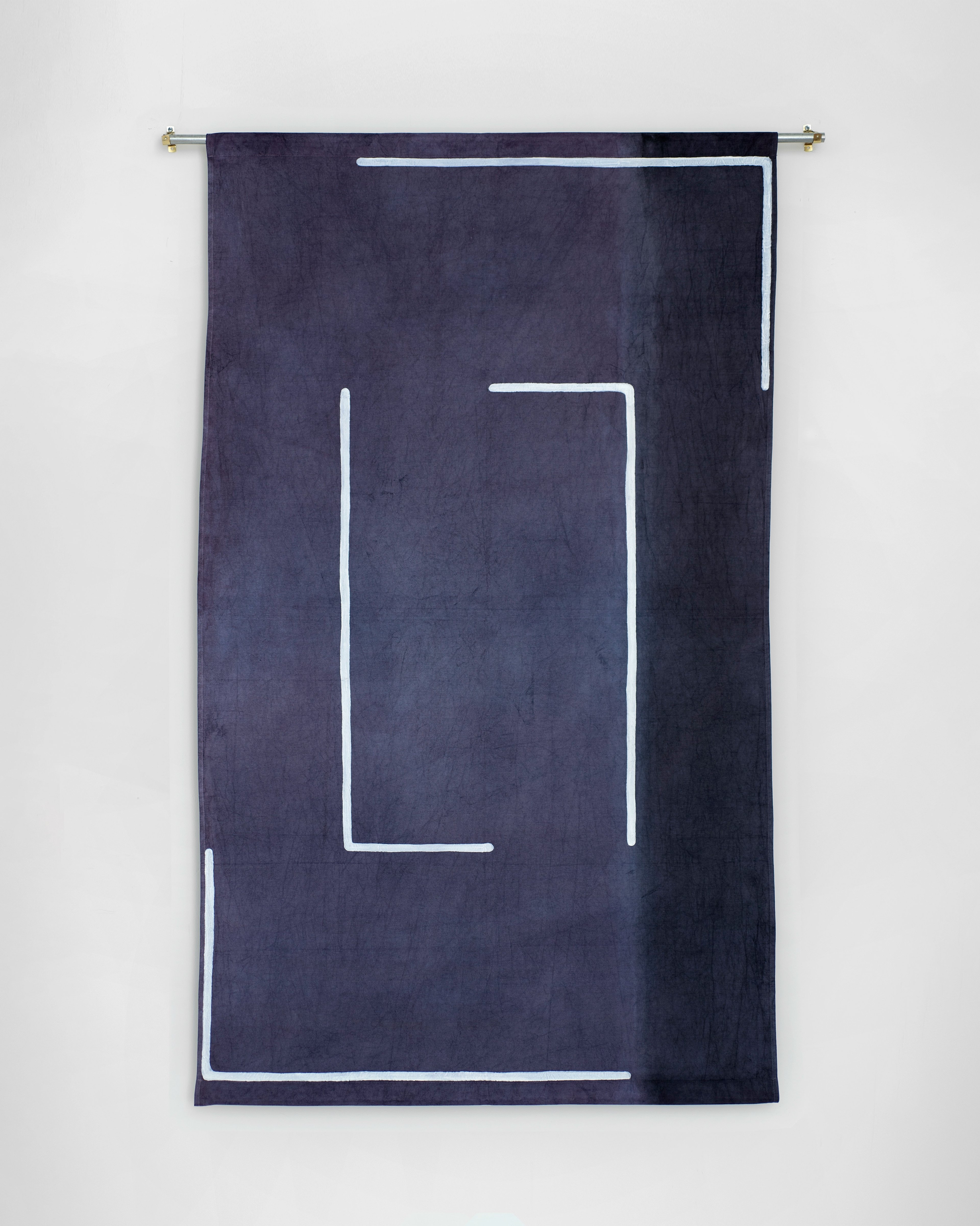 Dark navy cotton fabric hanging vertically with white geometric lines forming an abstract rectangular composition and border frame