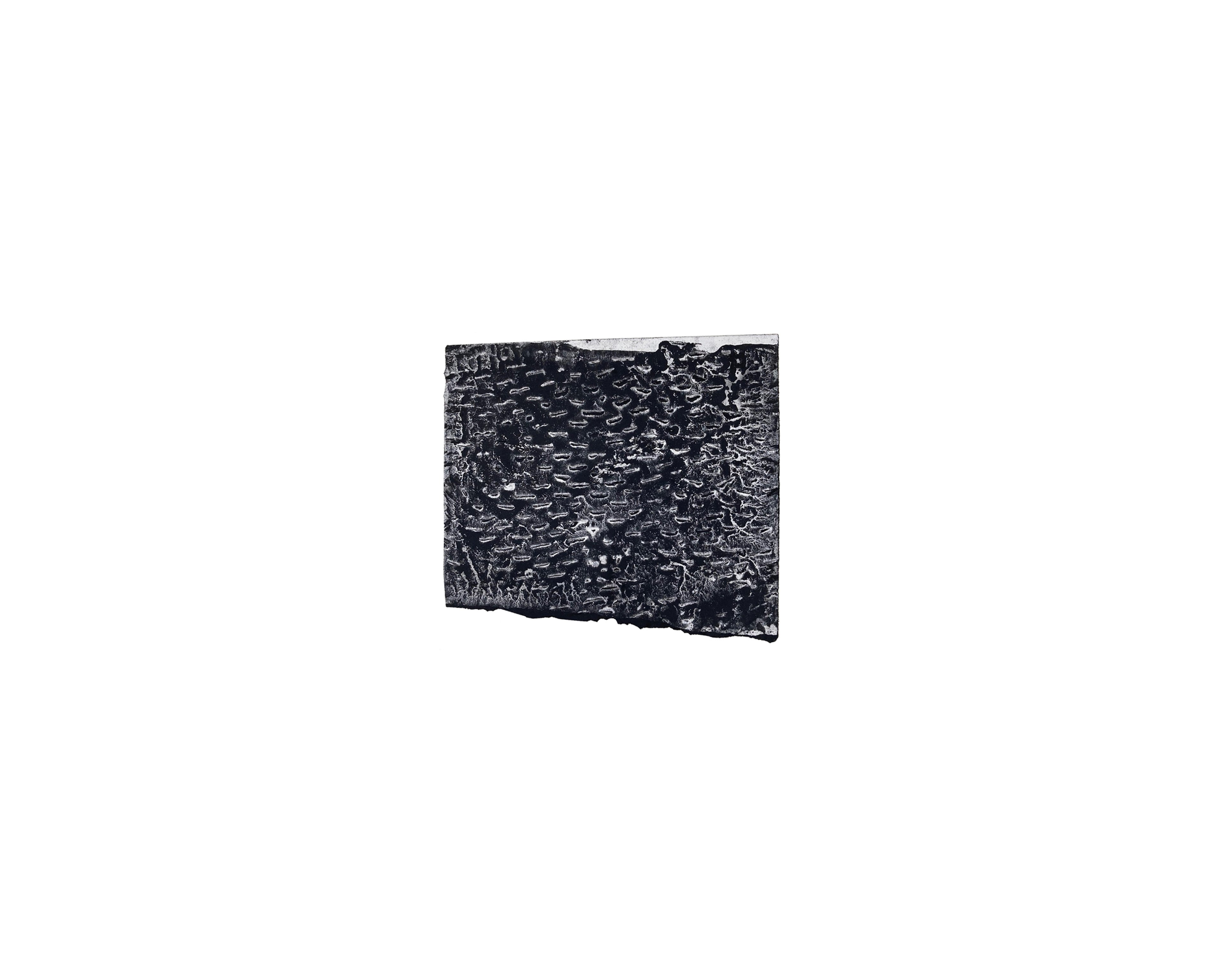 Black watercolour on paper with dense, gestural mark-making creating an intricate textured surface, tilted against a white background
