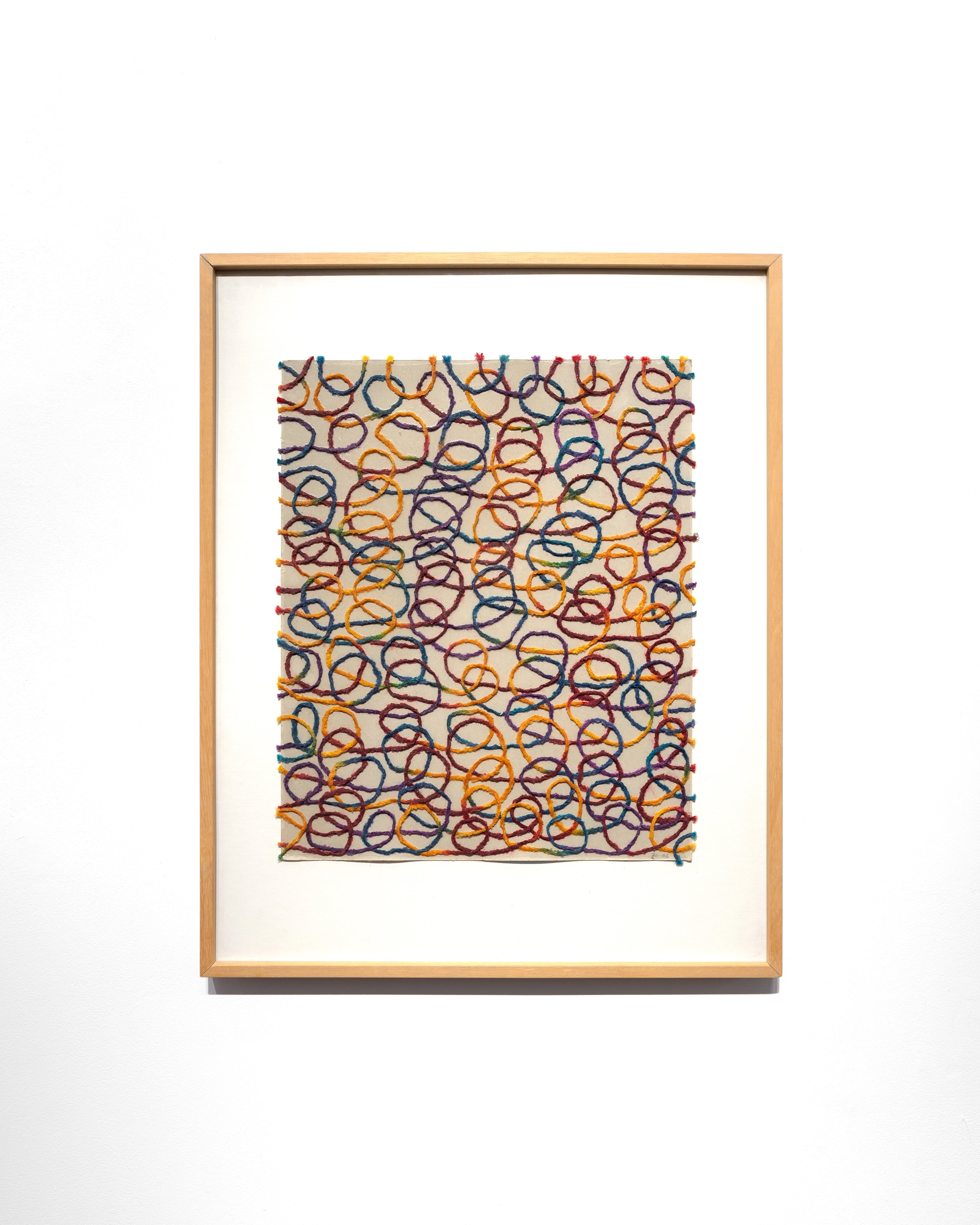 Dense composition of overlapping circular forms in orange, blue, and burgundy wool on cream board, creating an all-over abstract pattern reminiscent of inter…