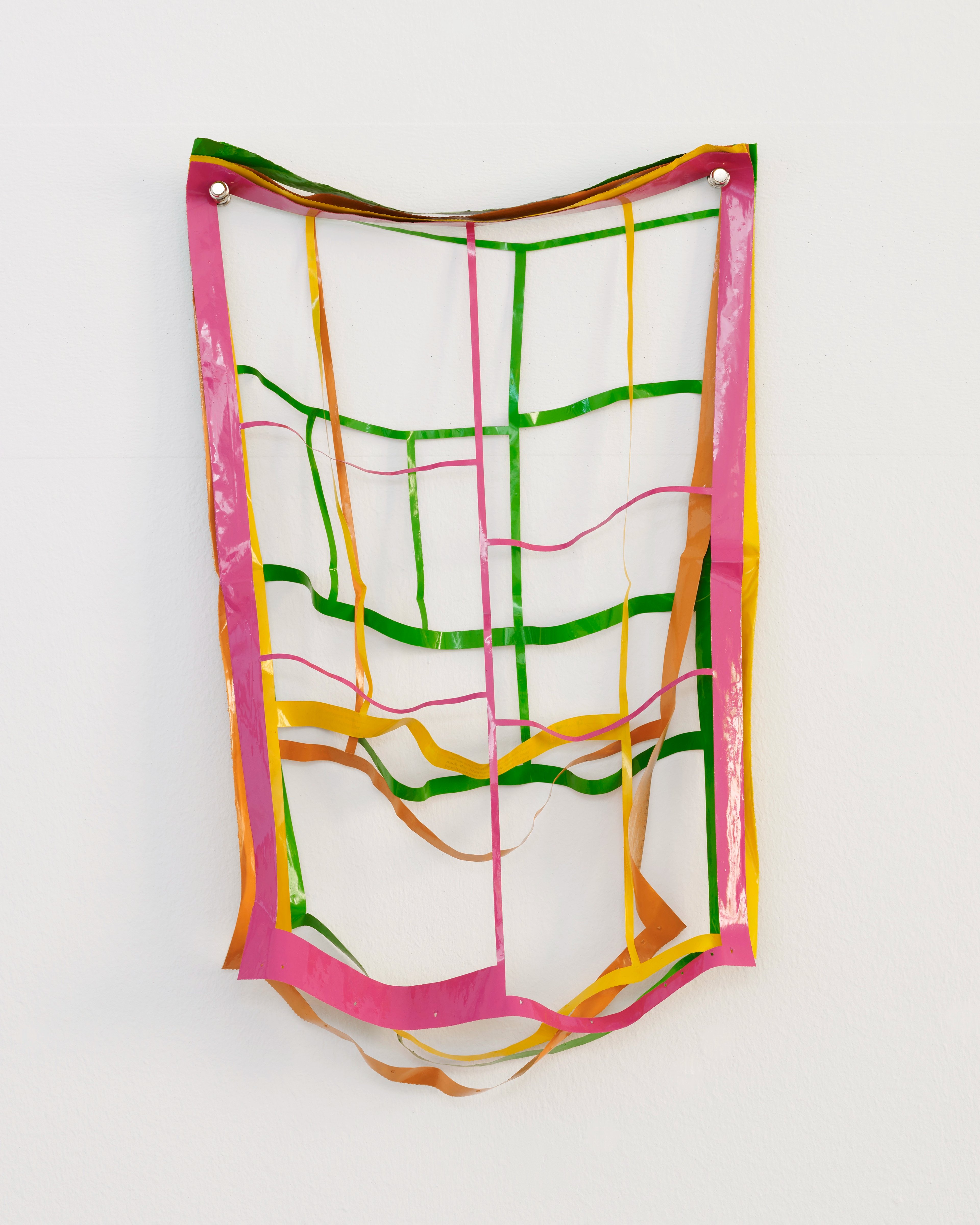 Vibrant lacquer-painted strips in pink, green, yellow, and orange form an interwoven grid structure suspended on white wall, with curved and undulating ribbo…