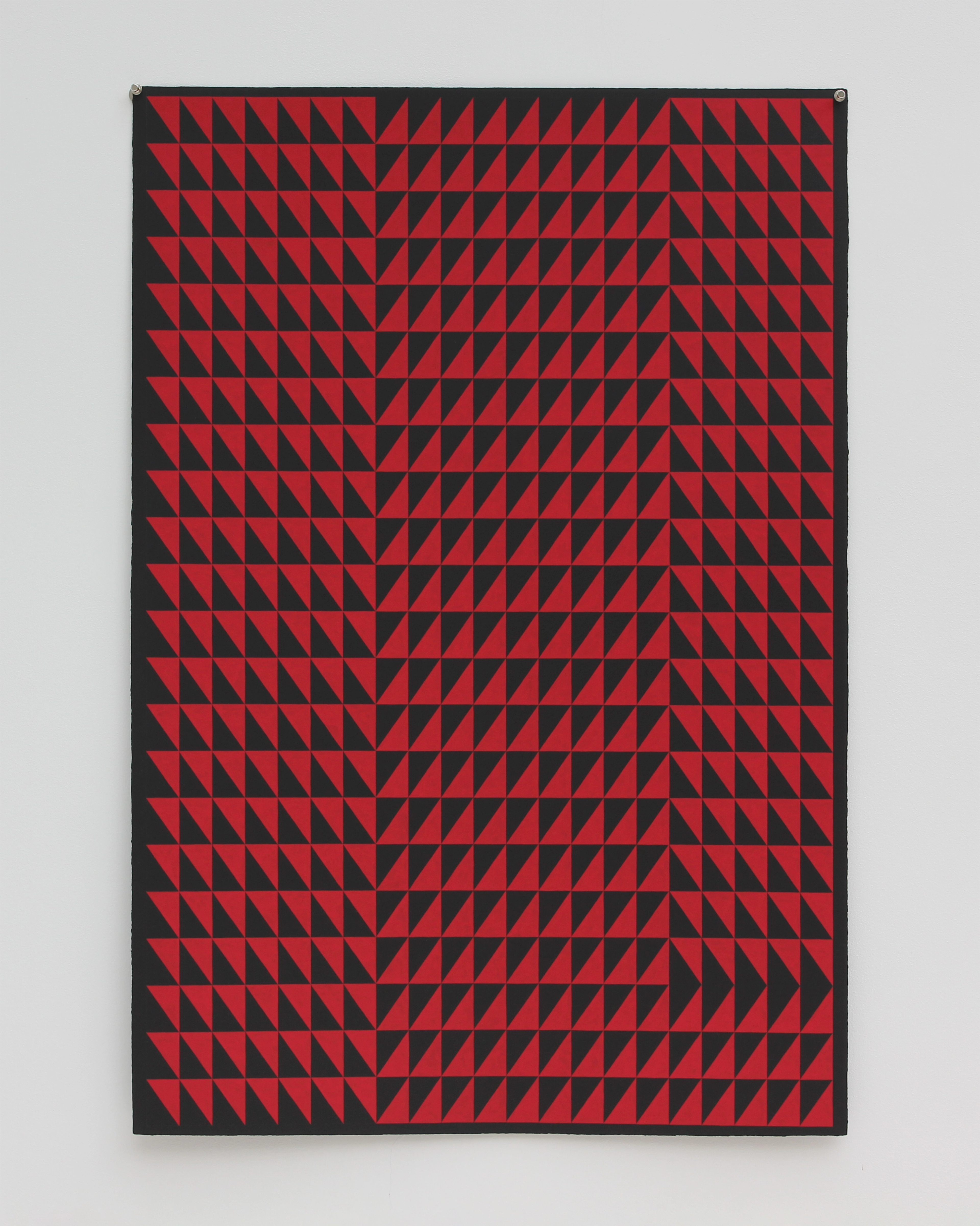 Geometric composition of repeating red triangles arranged in dense diagonal rows across a black ground, creating a rhythmic optical pattern