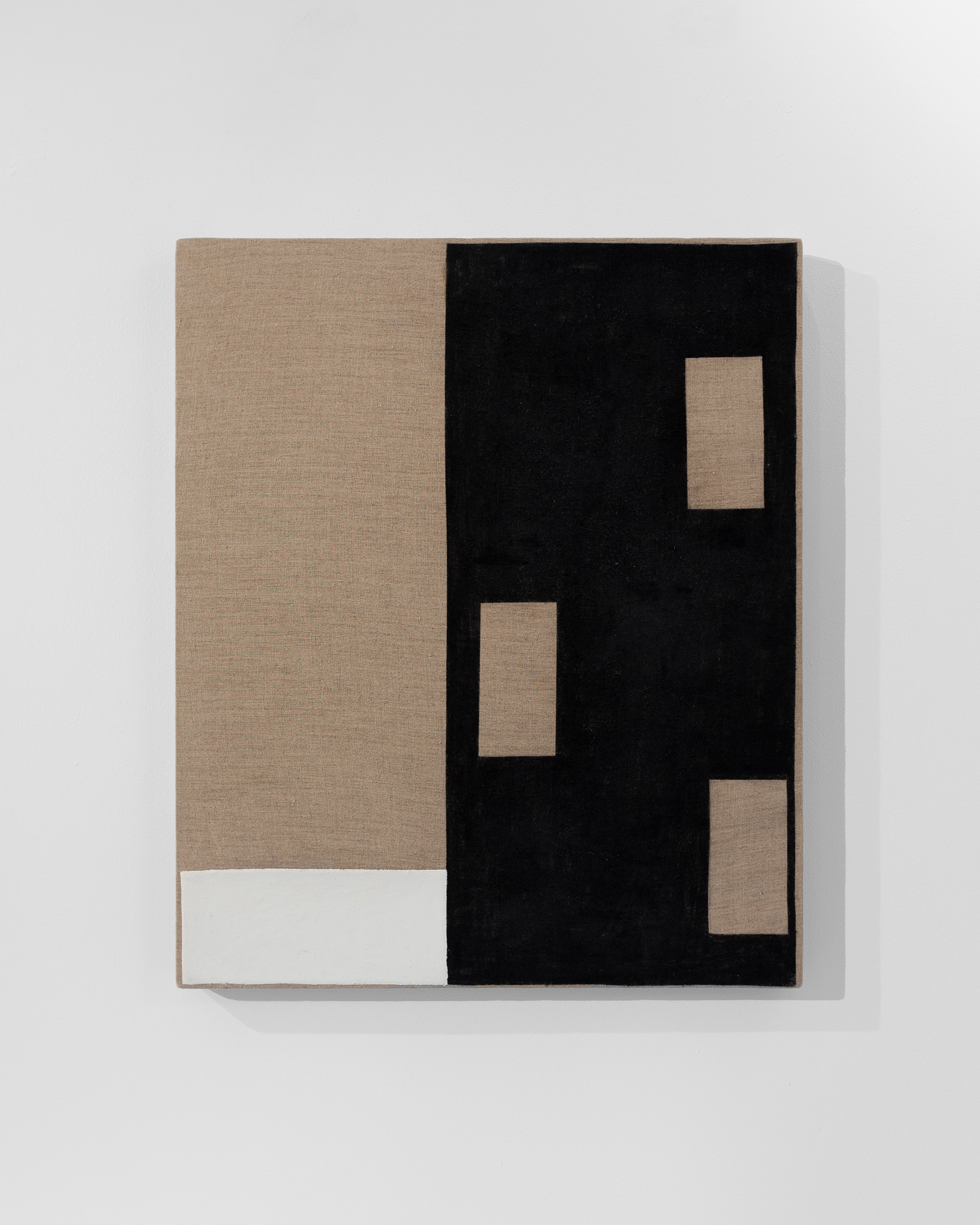 Geometric composition in charcoal and beeswax on linen divided into beige left panel and black right section with three rectangular cutouts revealing tan lin…