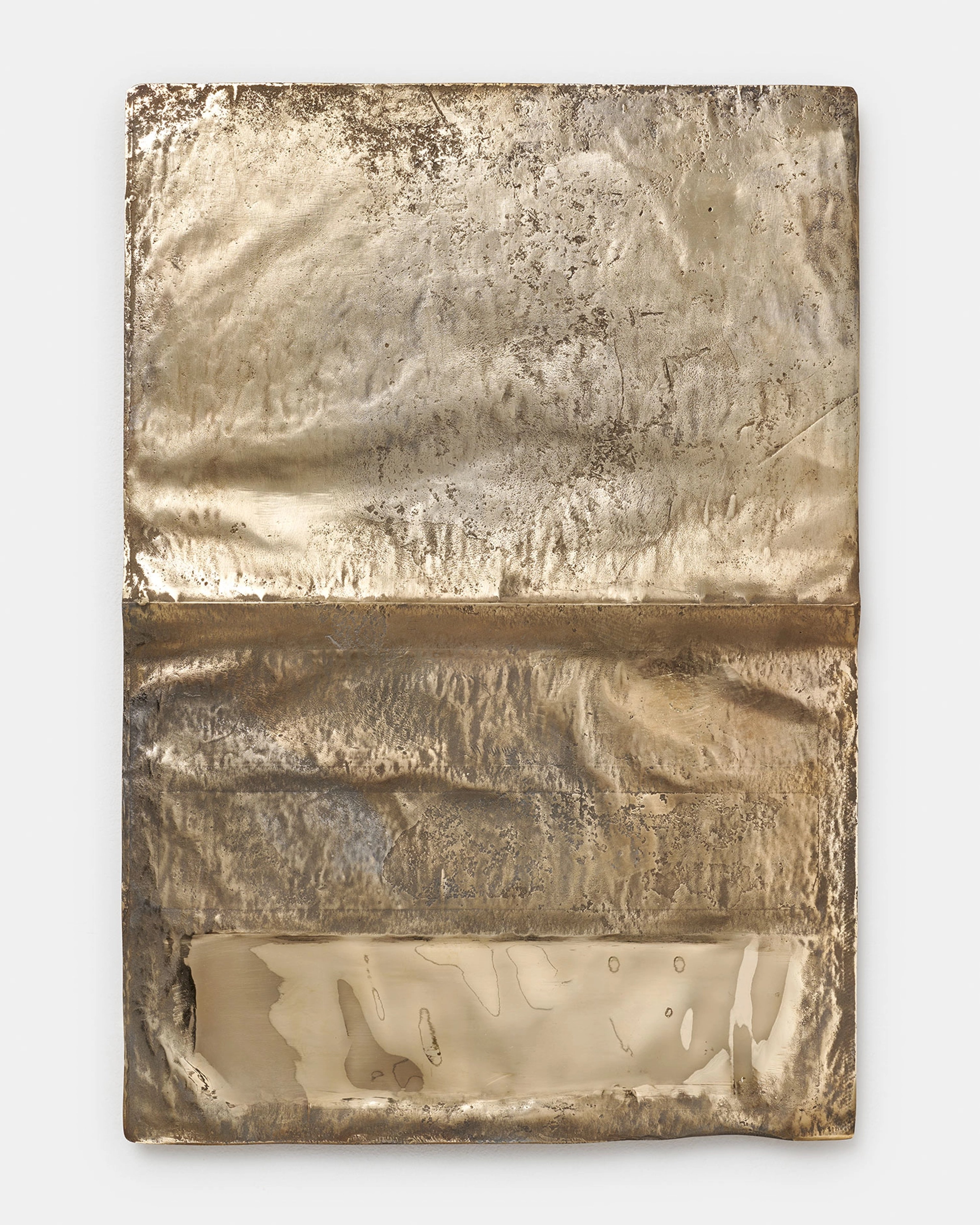 Textured bronze panel with three horizontal sections: upper two areas of weathered, granular surface and lower section revealing carved abstract forms and vo…