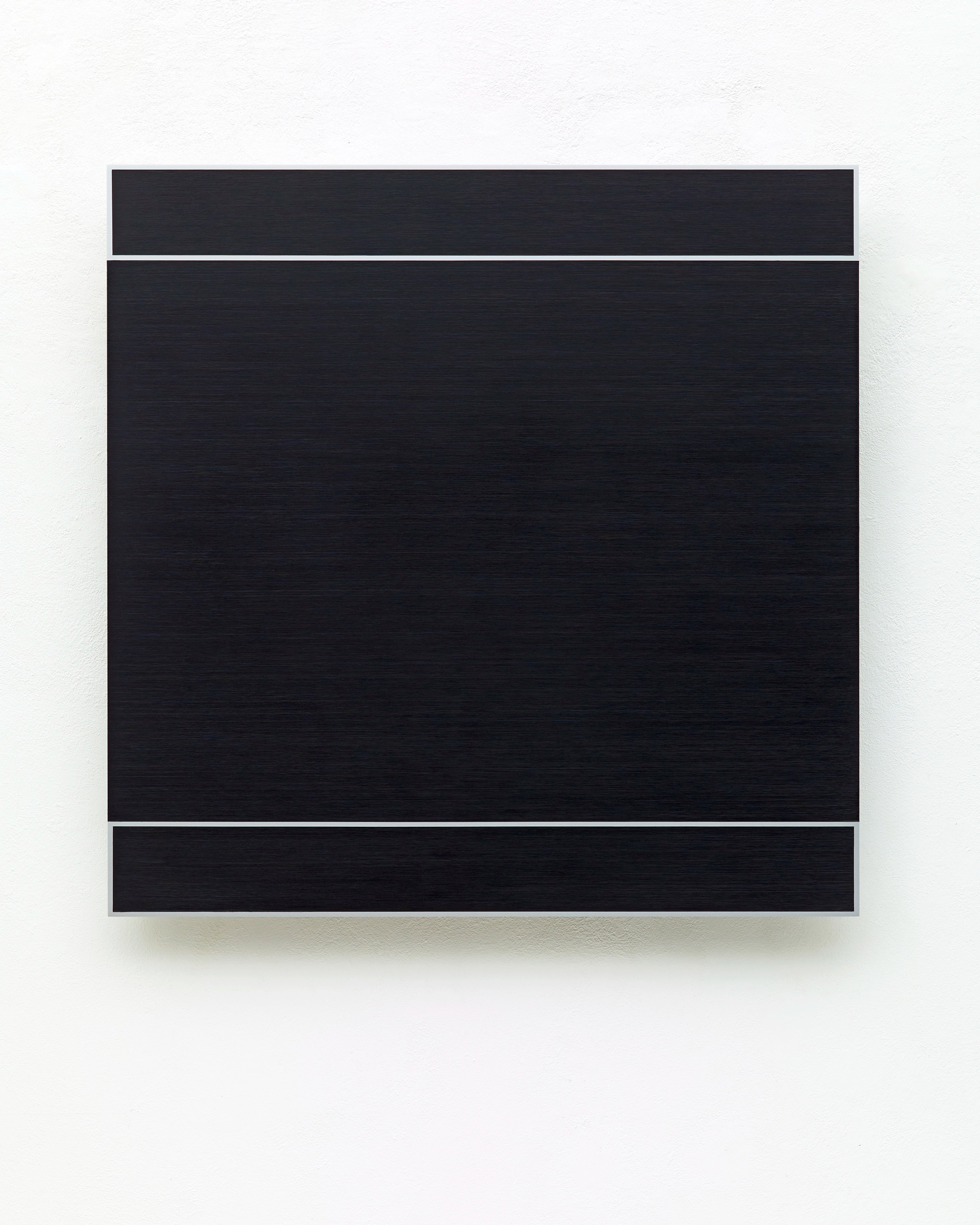 Three horizontal black painted bands separated by white gaps on anodised aluminium panel mounted on white wall