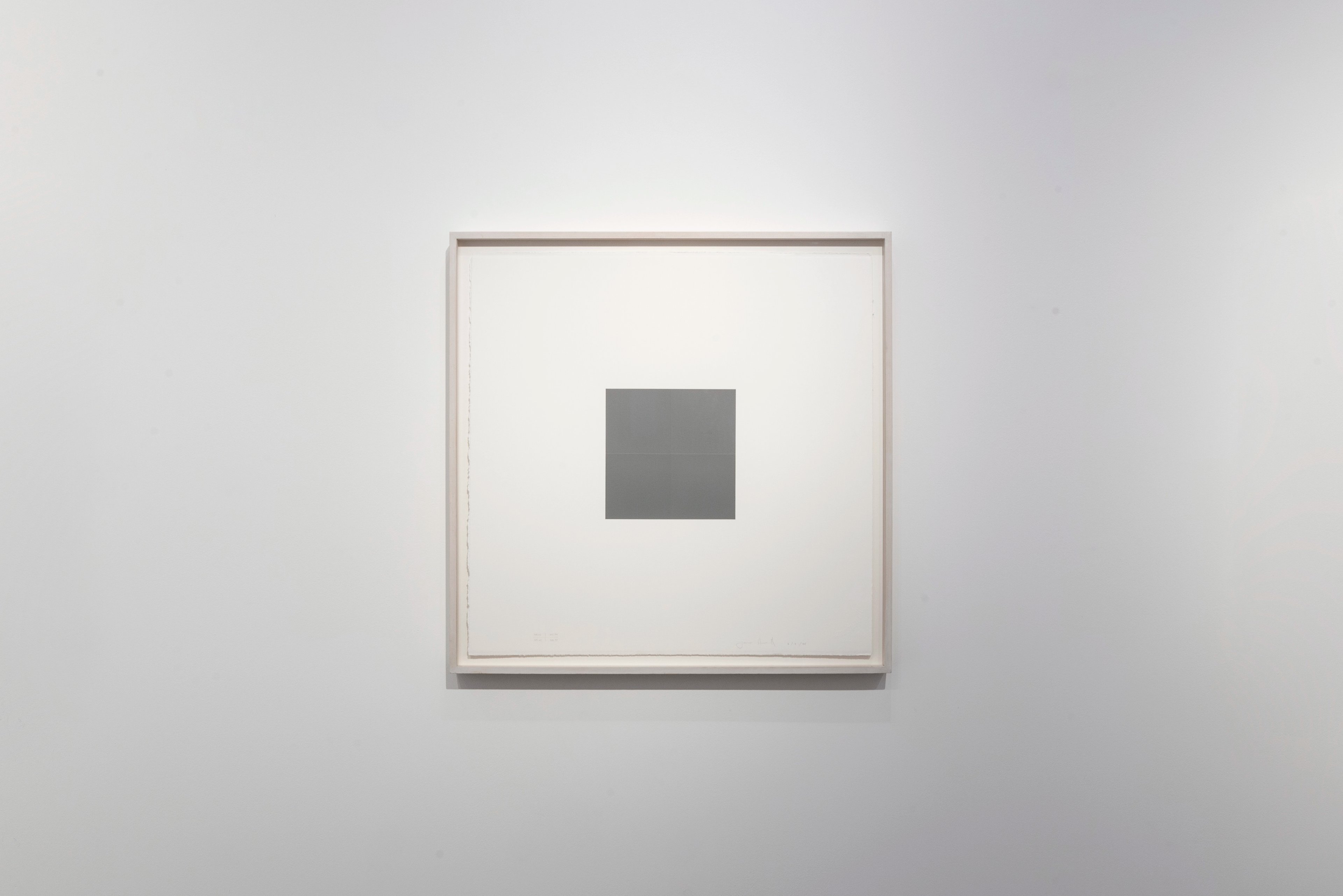 Framed acrylic on paper featuring a single dark grey square centered on cream ground within a light wooden frame
