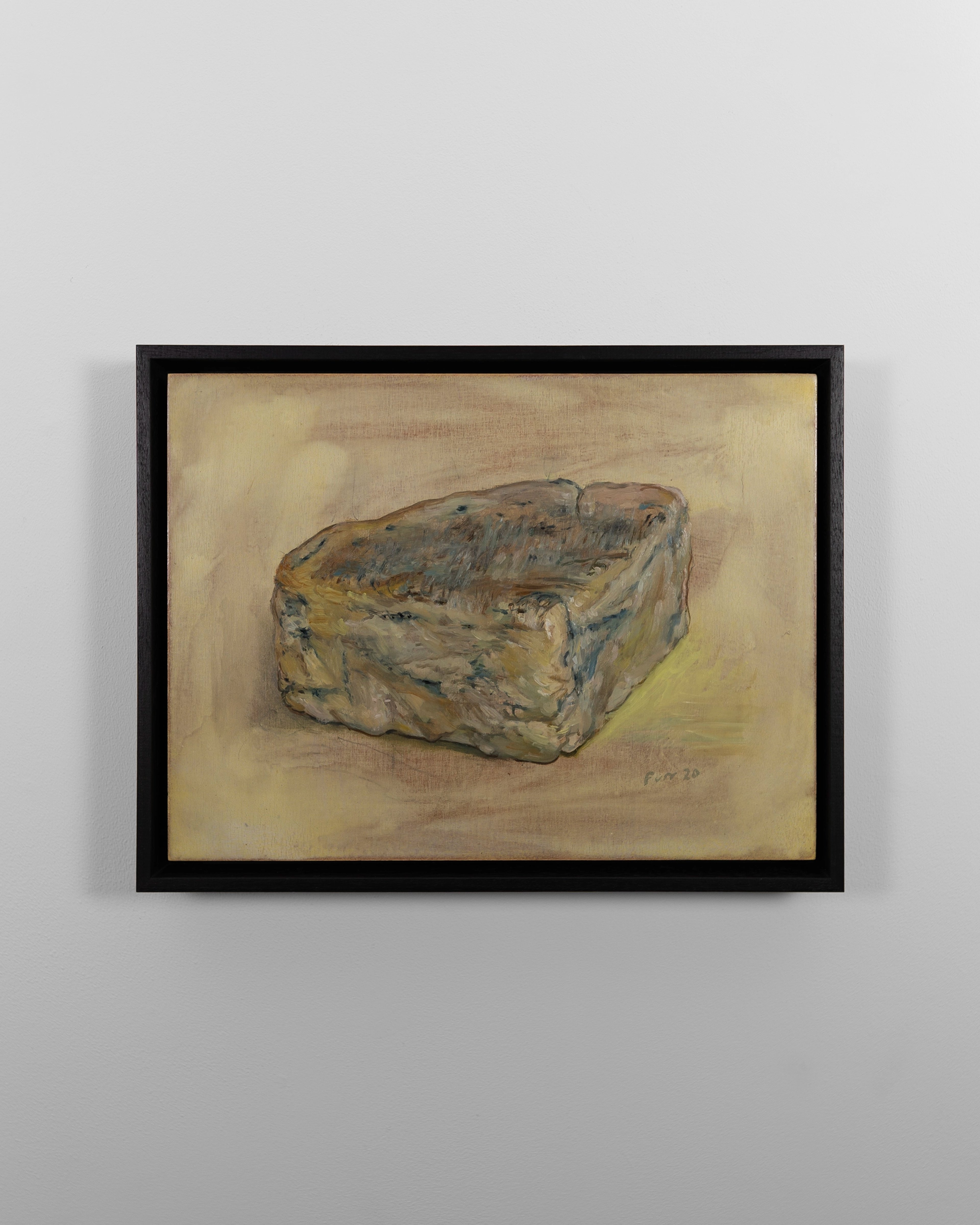 Oil painting of a wedge of blue-veined cheese rendered in ochre and grey tones against a pale yellow background, housed in a black frame
