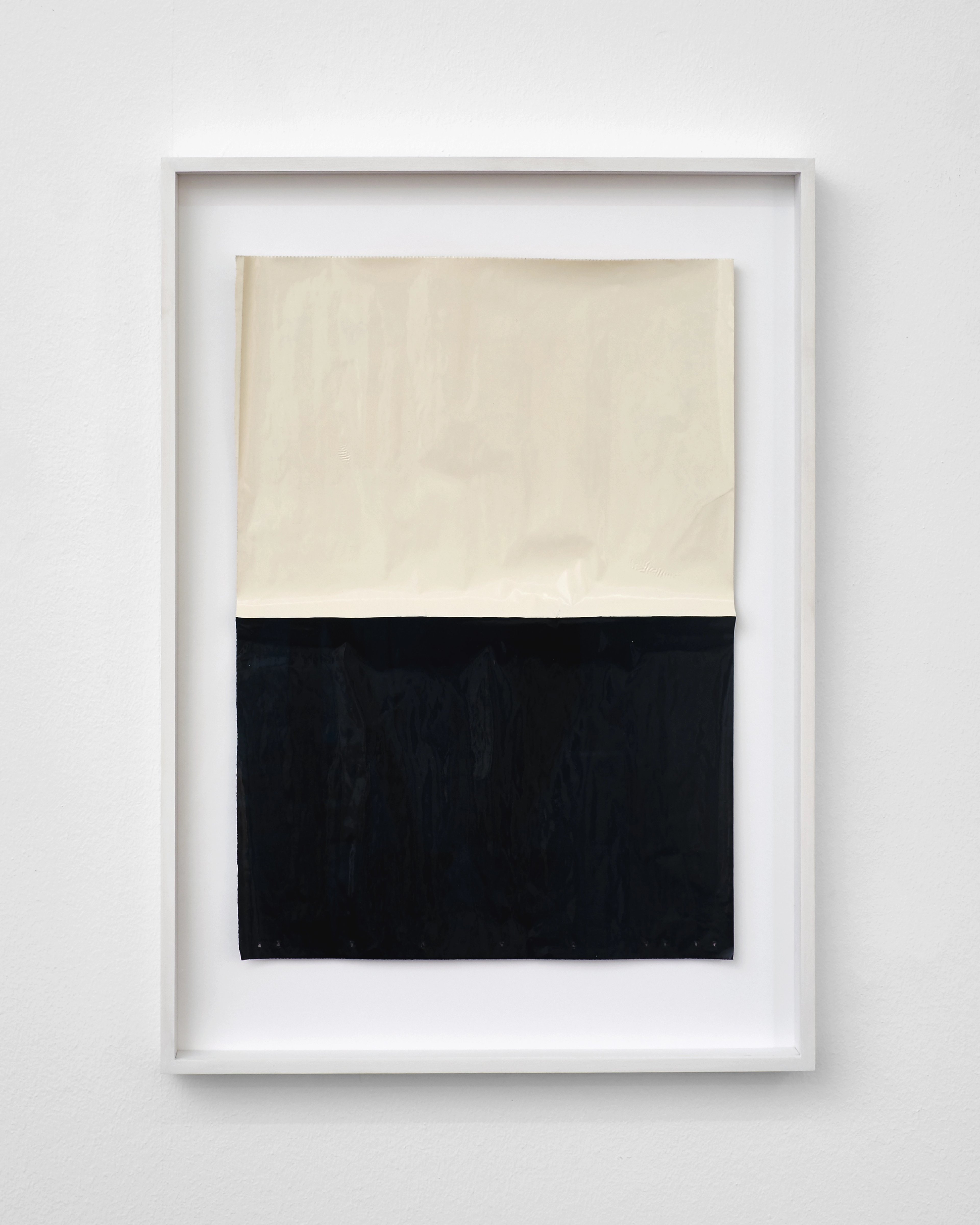Framed composition divided horizontally into cream and black sections on newspaper, painted with lacquer in a minimalist geometric arrangement