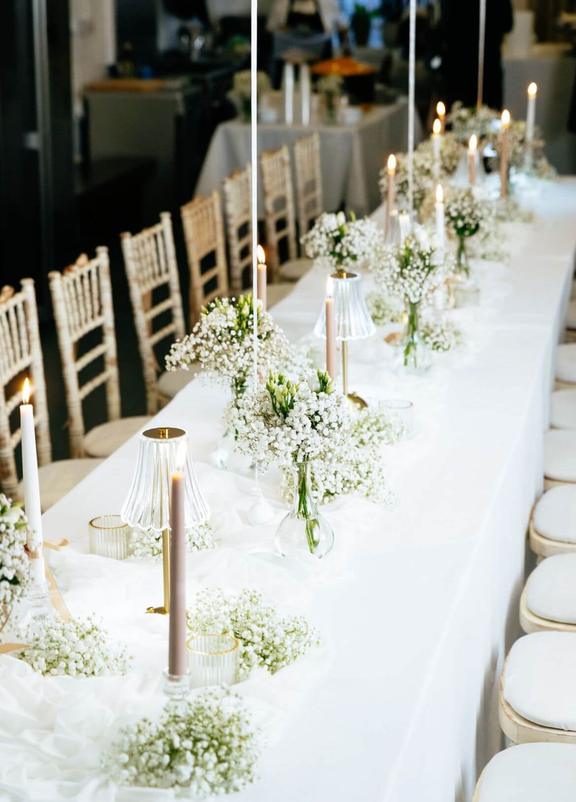 “Elegant long dining table set at Brixton Warehouse with candles, flowers and white linen for a supper club event.”