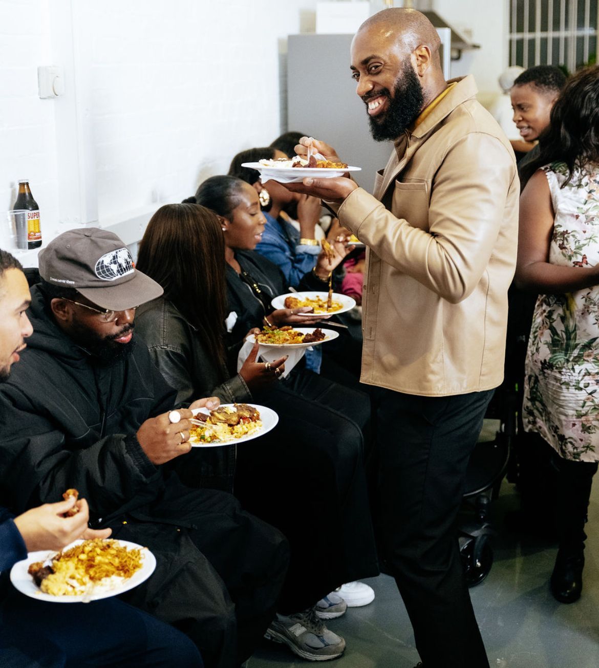 People eating at a party , relaxed vibe.