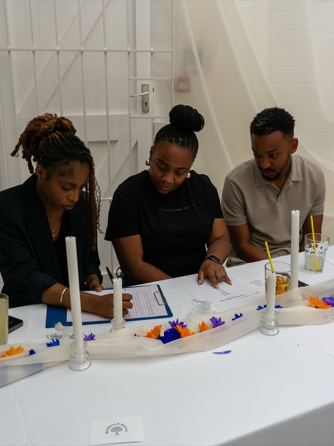 three people at a styled table taking aport in an activity