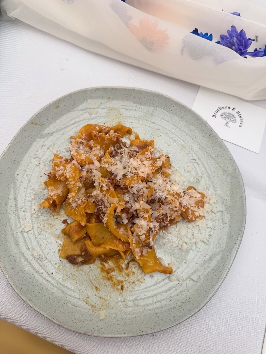Close in of plated pasta dish with flowers