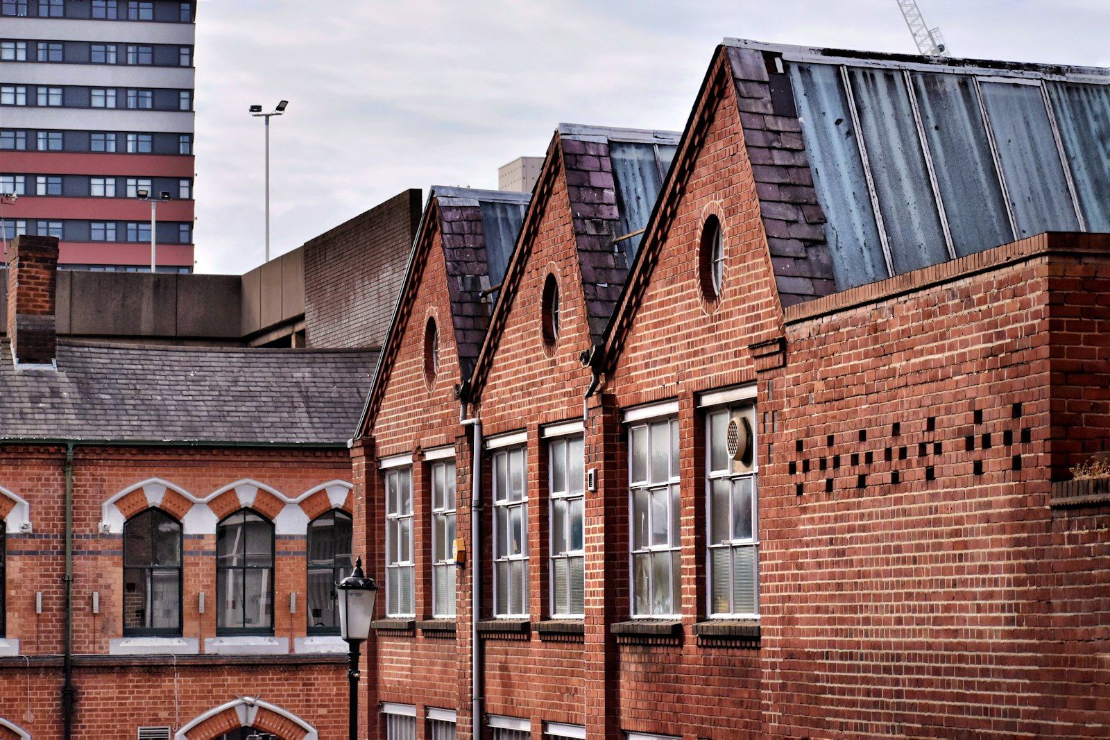 Victorian red brick buildings in Birmingham Jewellery Quarter under a pale sky