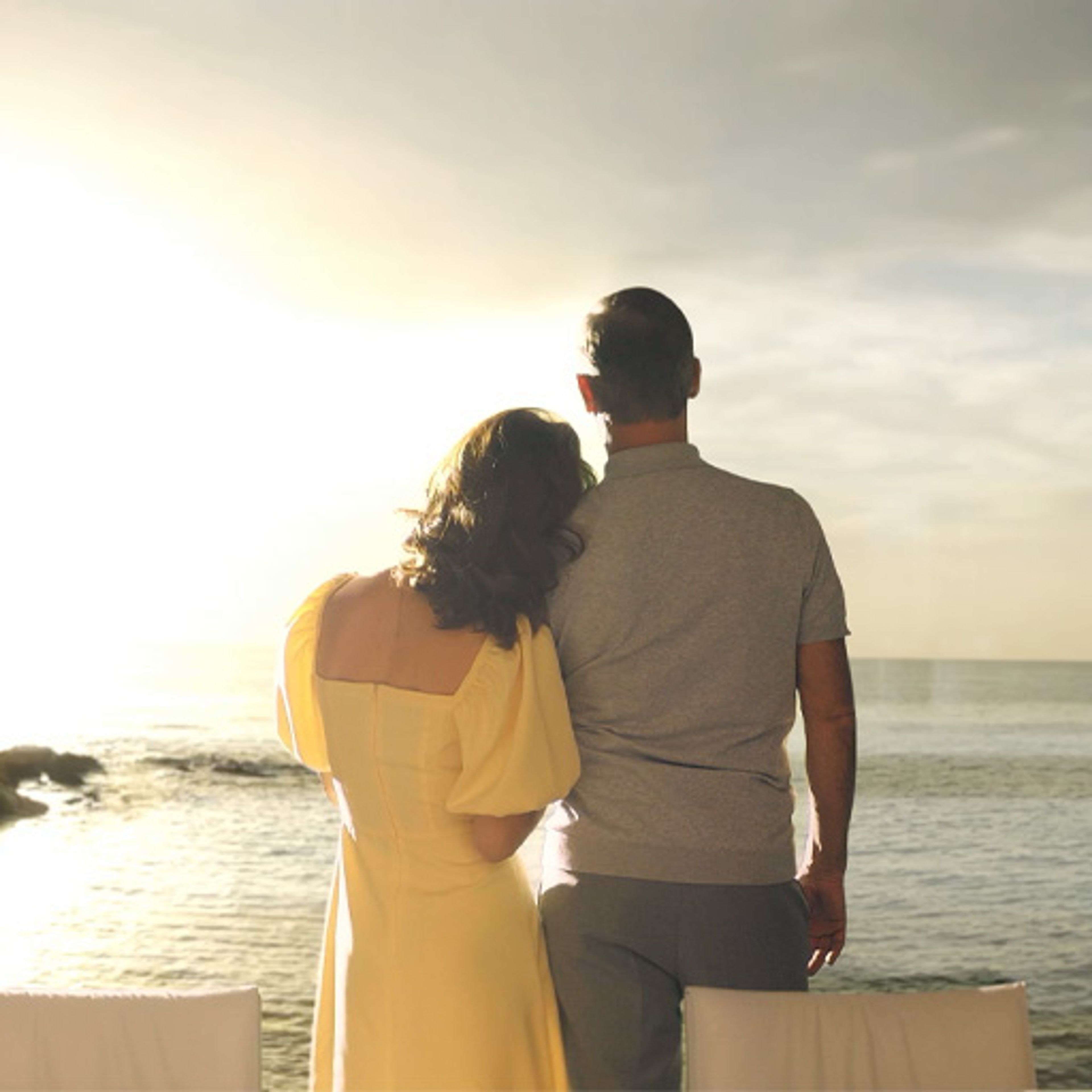 Couple watching the Mediterranean sunset from a luxury seaside home in Cyprus.