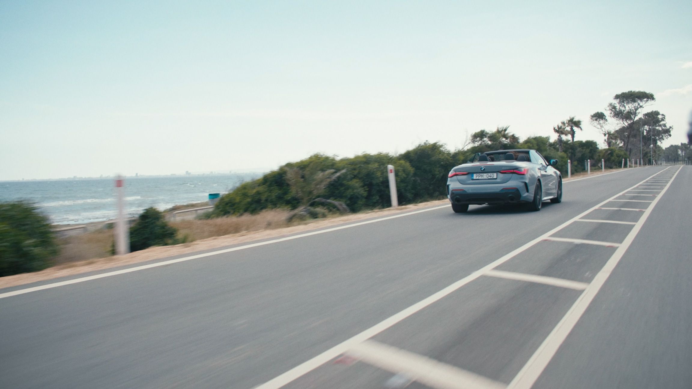 Convertible driving along a coastal road in Cyprus