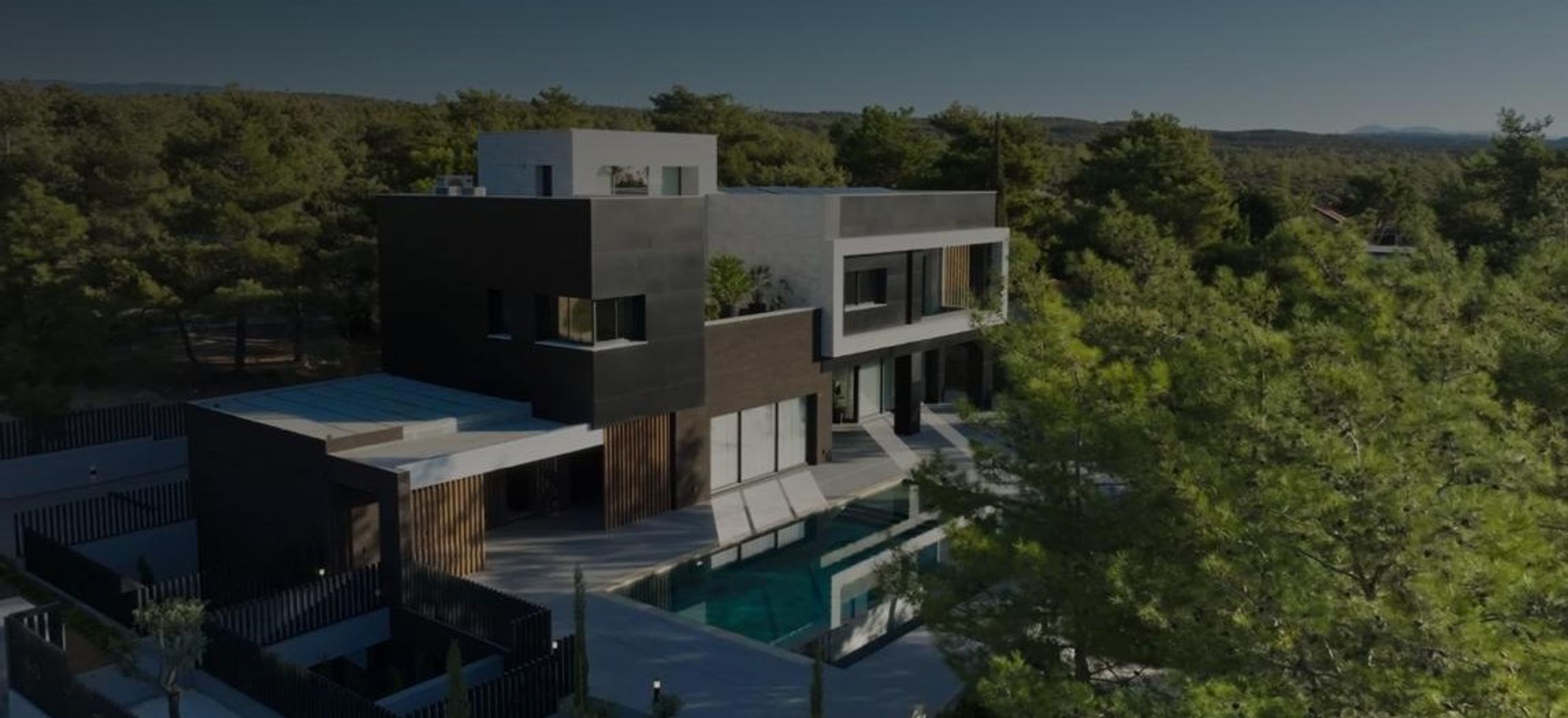 Aerial view of a modern villa among pine trees