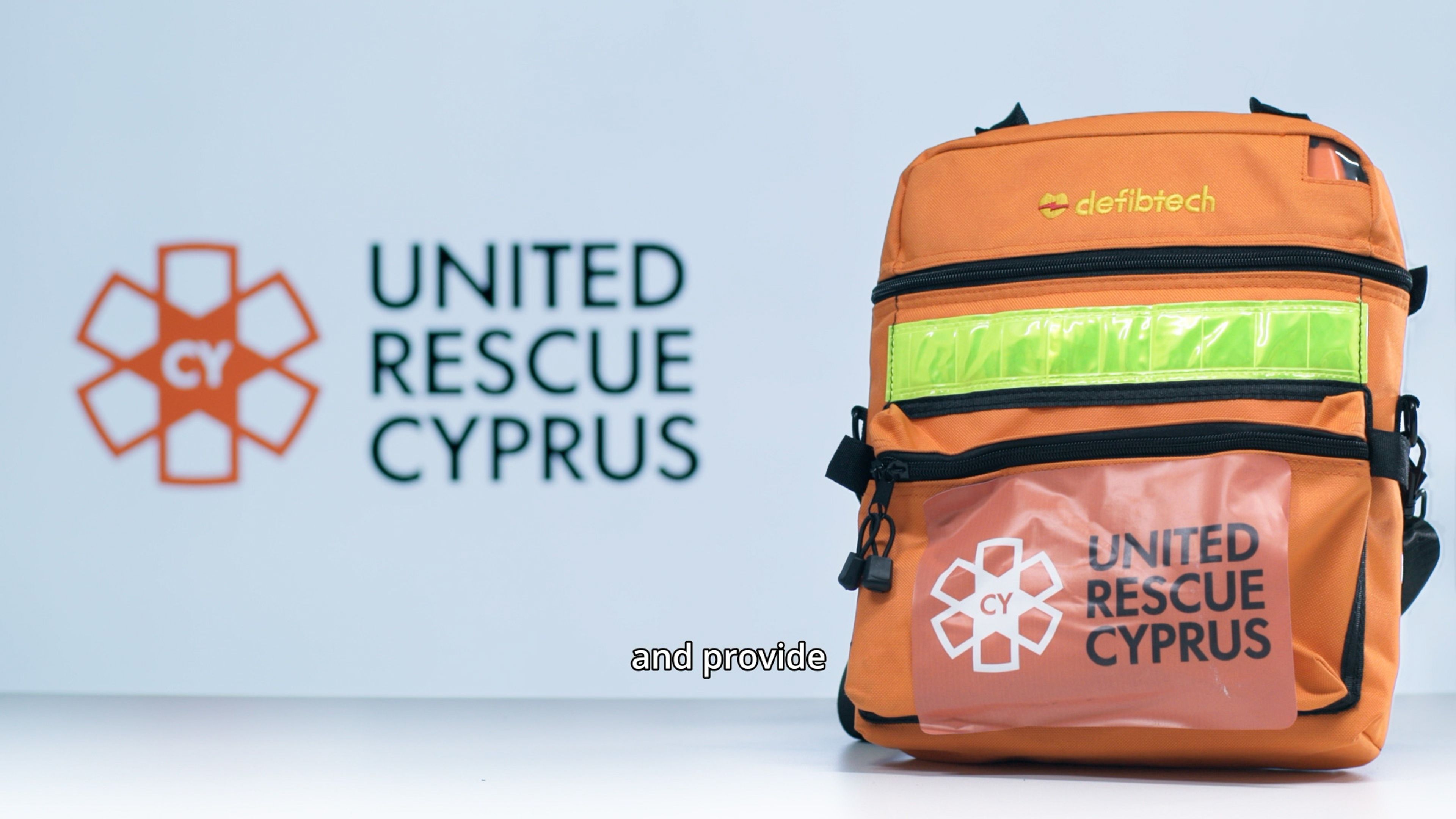 Orange United Rescue Cyprus emergency medical backpack displayed beside the organisation’s logo.