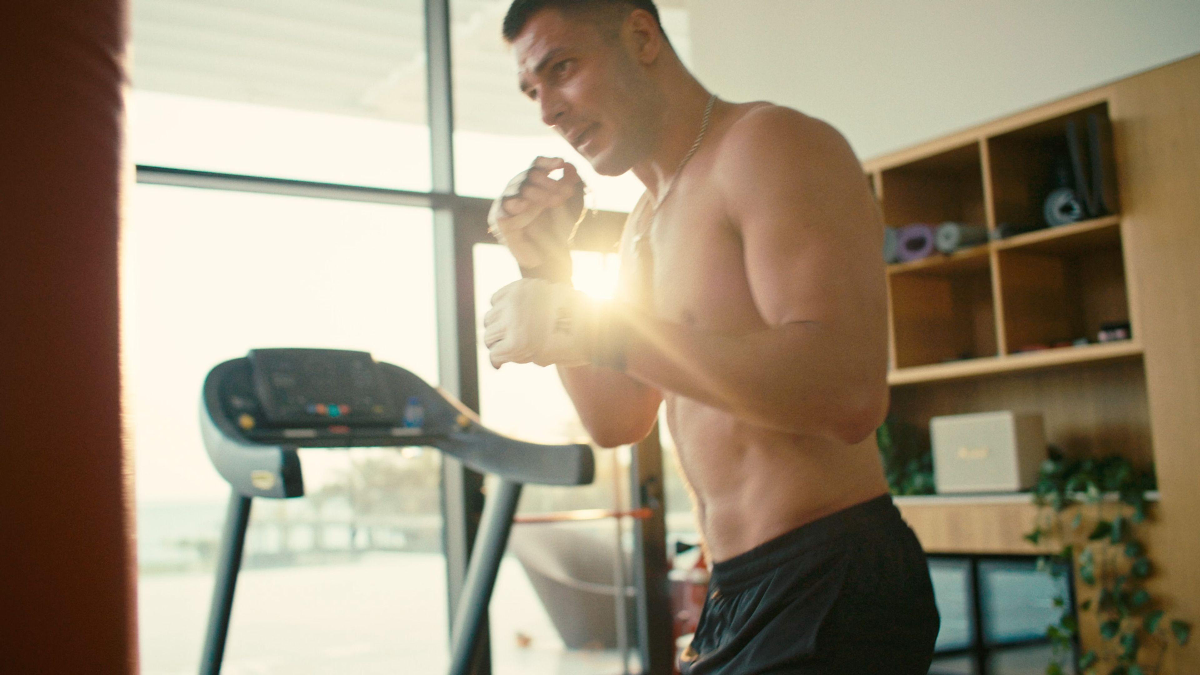 Close-up of a man boxing in a bright gym