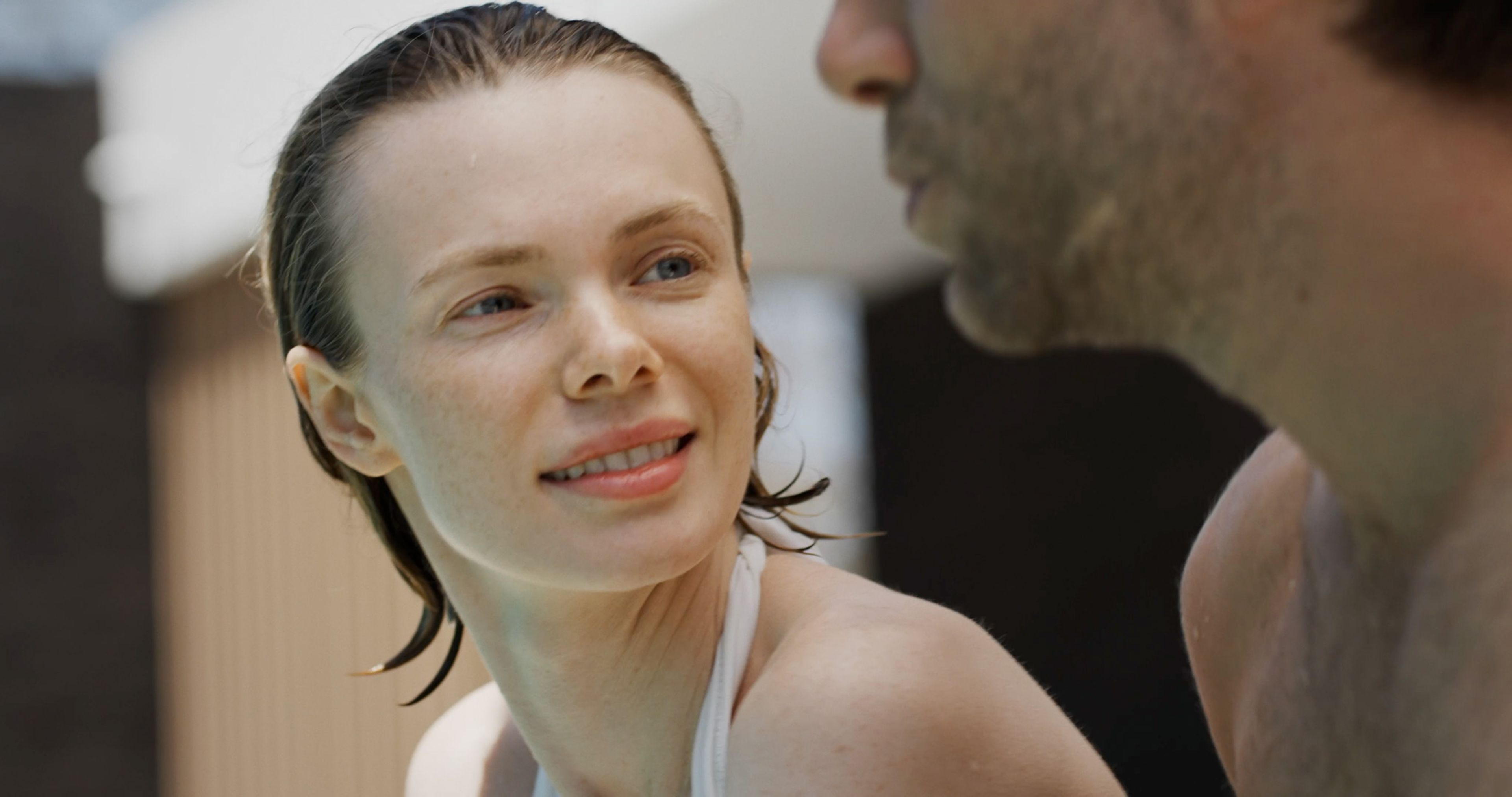 A young couple sharing a moment after swimming.