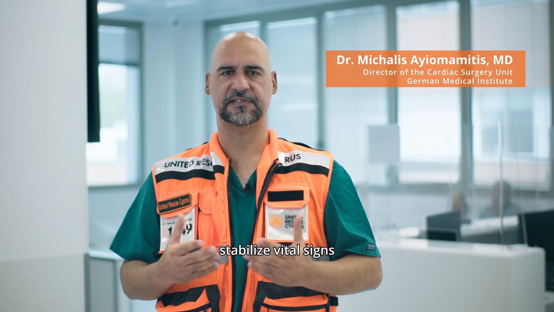 Dr Michalis Ayiomamitis wearing a United Rescue Cyprus vest and explaining emergency medical response.