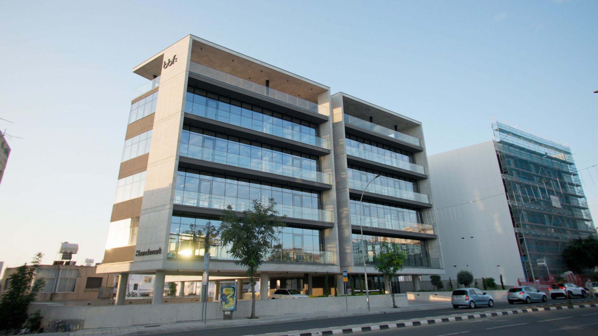 Street view of a glass-fronted bbf: commercial building in Limassol, Cyprus.