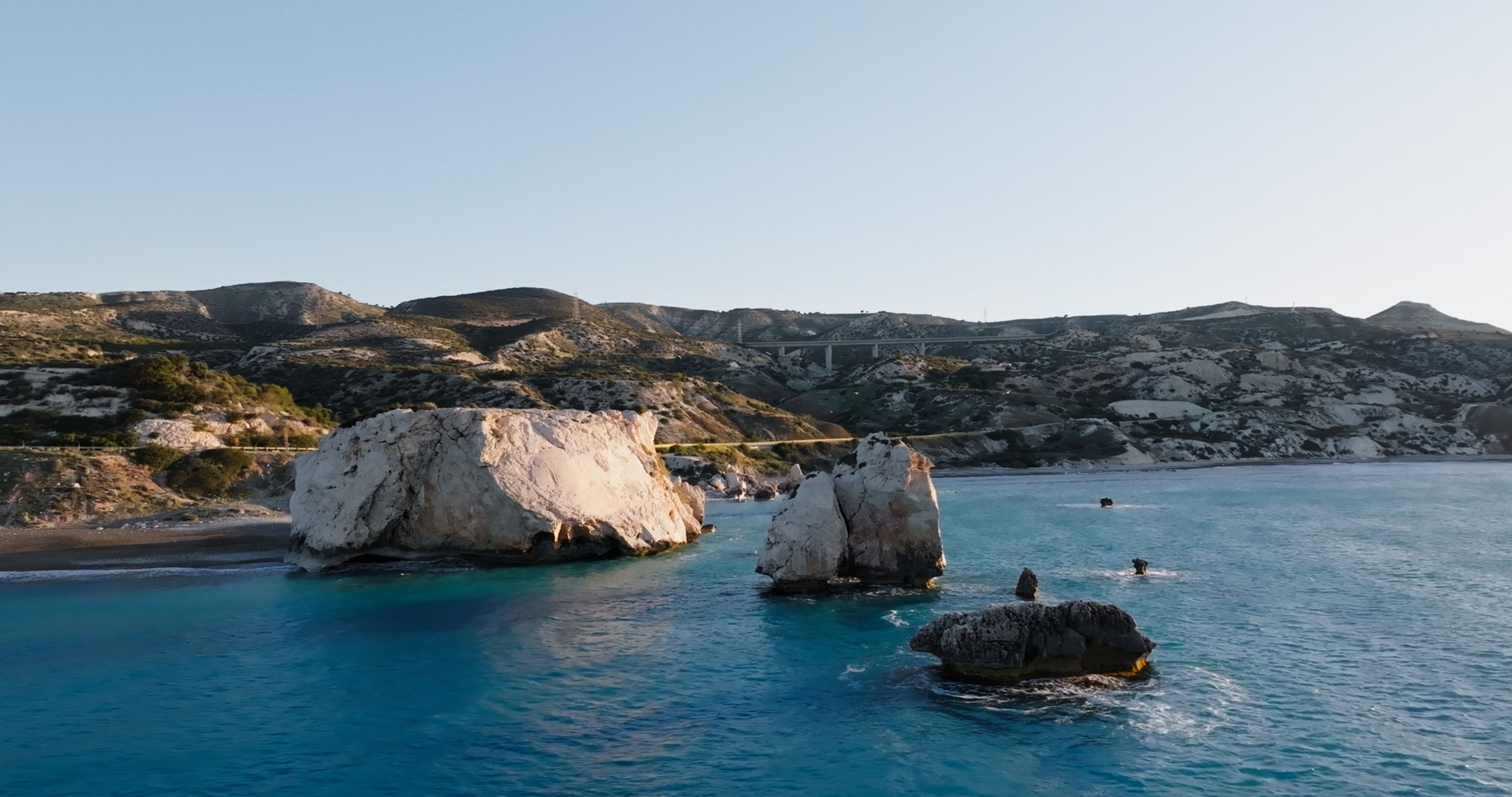Aerial view of the Cyprus coastline with large white sea rocks.