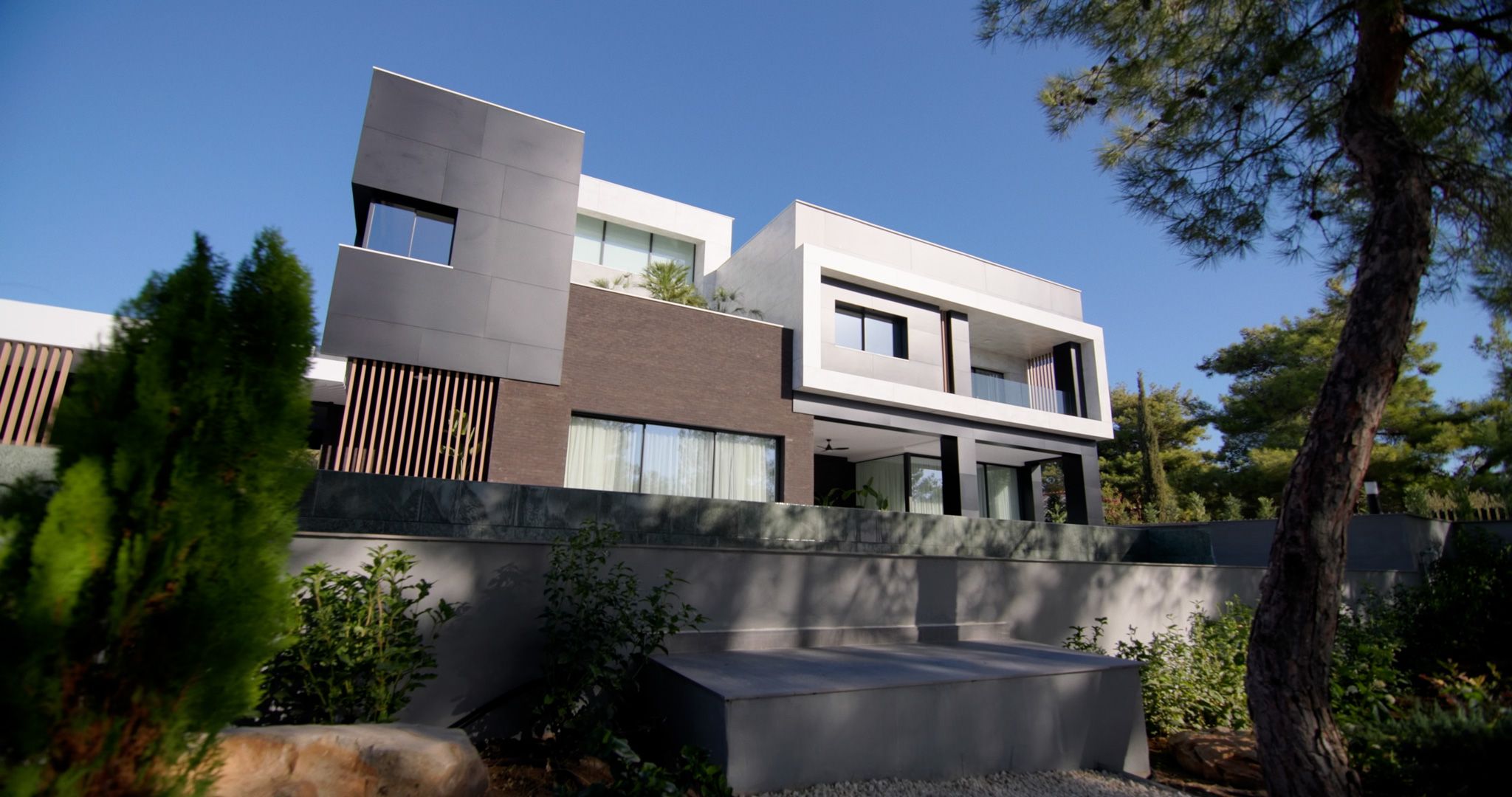 Modern luxury villa surrounded by pine trees in Cyprus.