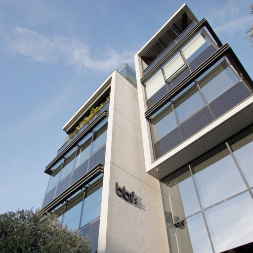 Low-angle view of a modern bbf: commercial office building in Limassol, Cyprus.
